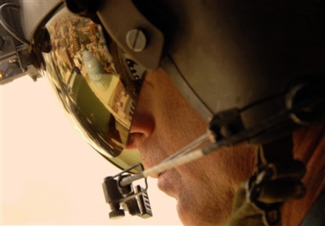 U.S. Army Sgt. 1st Class Darrel Salmon observes the landscape as he mans an M-240 machine gun in an UH-60 Black Hawk helicopter flying over Baghdad, Iraq, on Oct. 9, 2007.  Salmon is assigned to Charlie Company, 227th Aviation Regiment.  