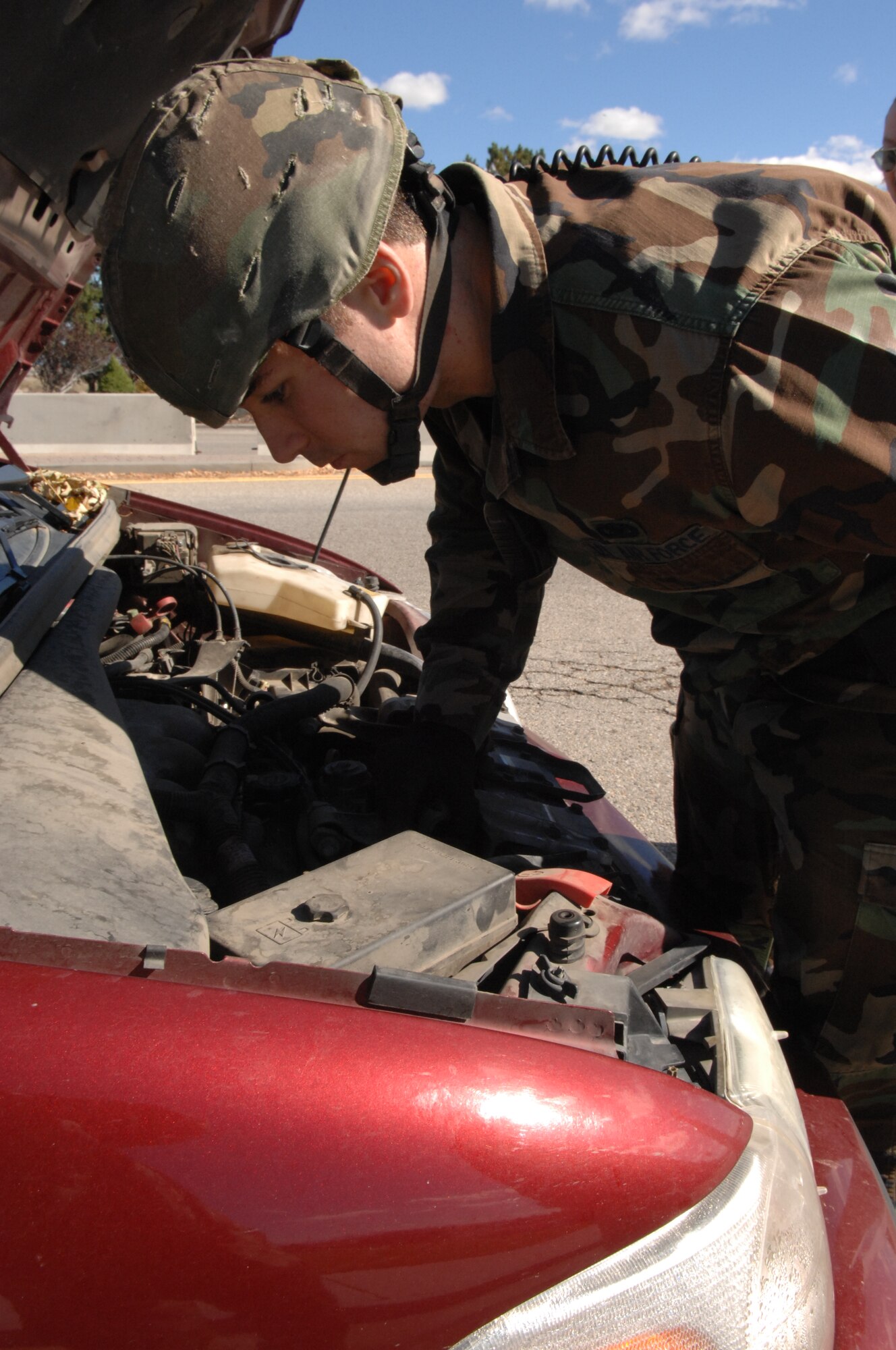 MOUNTAIN HOME AIR FORCE BASE, Idaho -- Senior Airman Paul Blaikie, 366th Security Forces Squadron, conducts an inspection on a vehicle entering the base following an increased threat condition during an exercise scenario here Oct. 21. Gunfighters are participating in Sharpshooter Exercise 08-01 in preparation for the March 2008 operational readiness inspection. (U.S. Air Force photo/Staff Sgt. Kathy Parker)