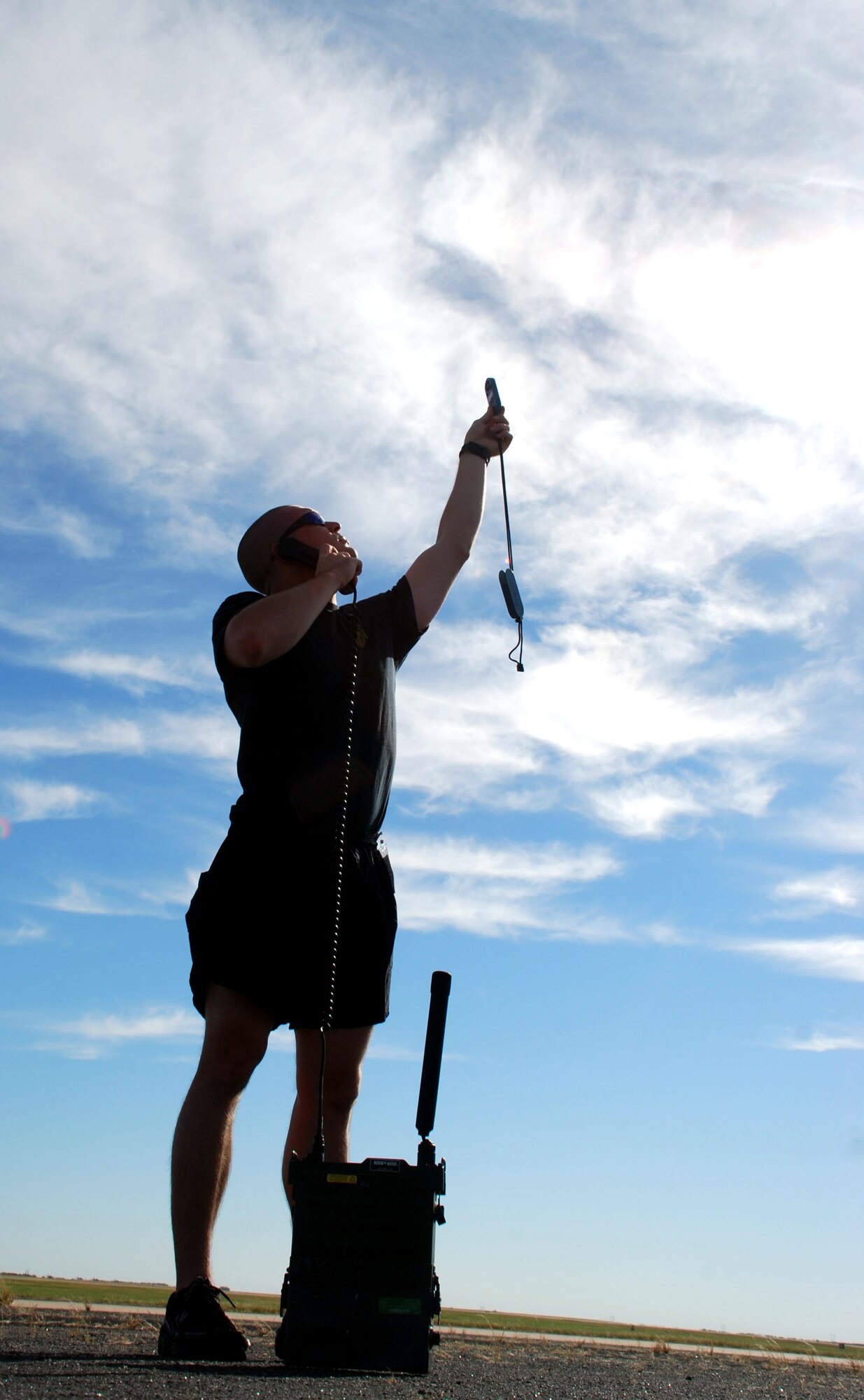 Army Sgt. Jess Counts, a parachute rigger with the Special Operations Command Parachute Team, measures wind speed prior to his teammates demonstration jump out of a C-130 Hercules at the Sheppard Open House and Air Show Oct. 20. (U.S. Air Force photo/Airman 1st Class Jacob Corbin))