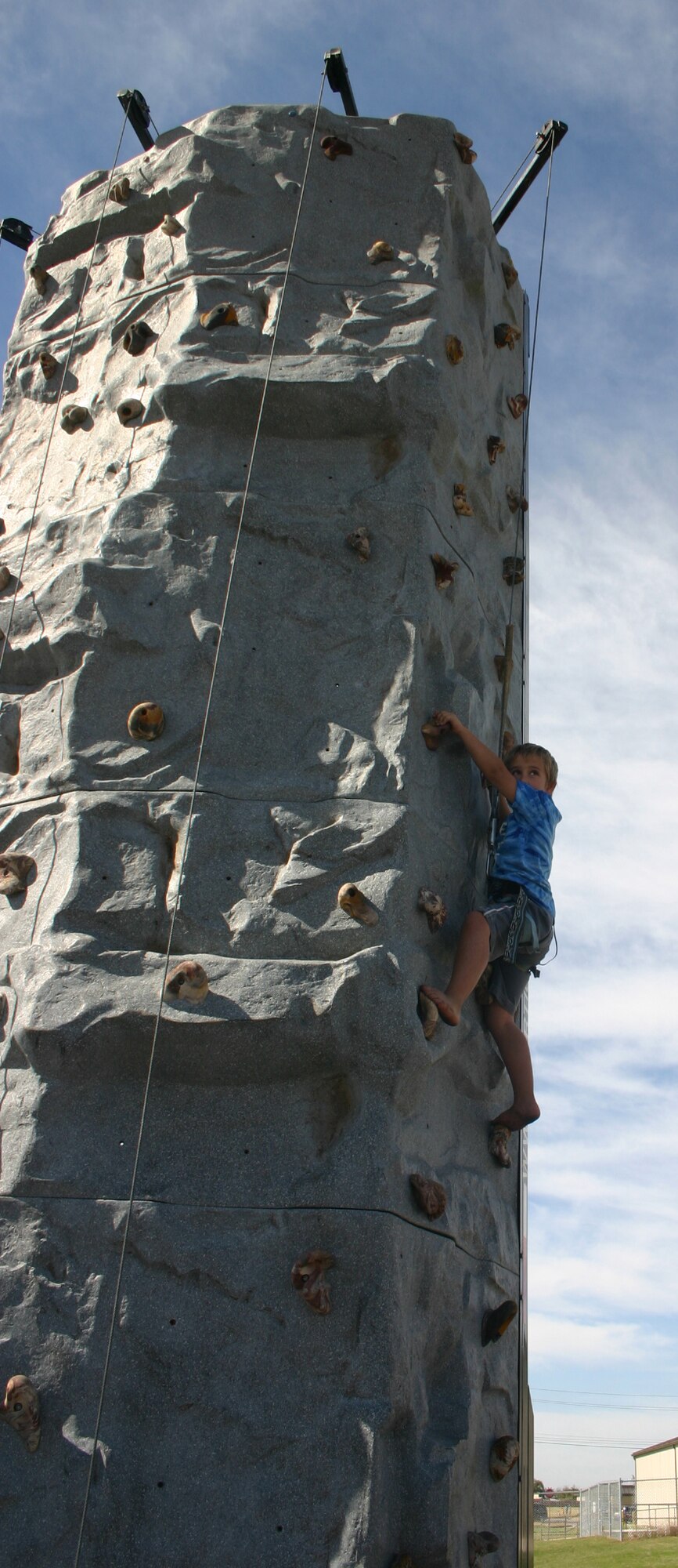 Dustin McDevitt makes his way up the rock-climbing wall provided by the 365th Training Squadron during the Sheppard Open House and Air Show Oct. 20. (U.S. Air Force photo/Staff Sgt. Tonnette Thompson)