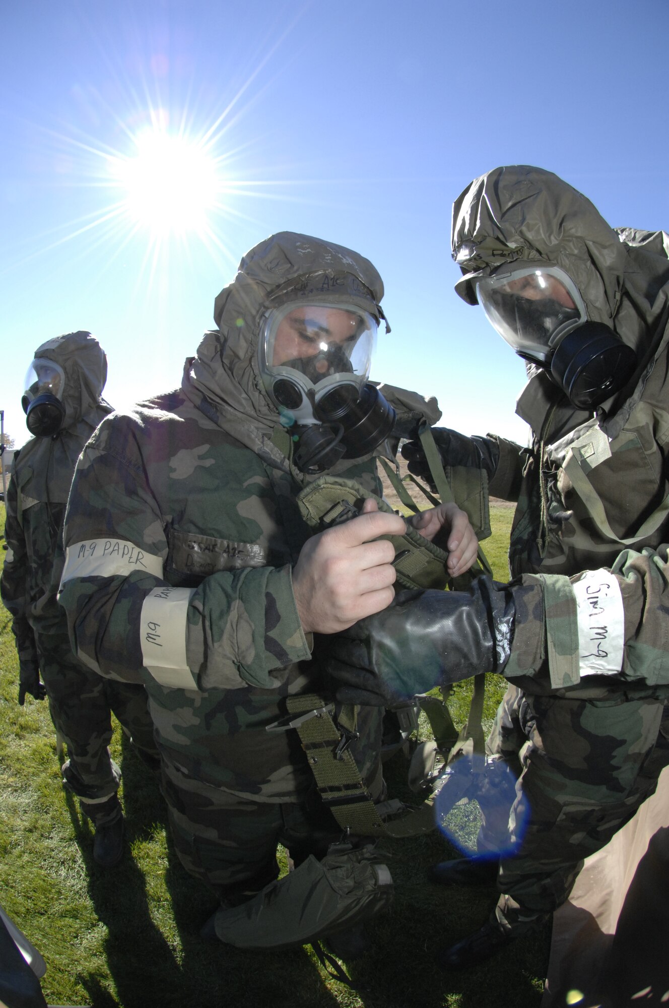 MOUNTAIN HOME AIR FORCE BASE, Idaho -- Airman 1st Class Michael Downey and Airman 1st Class Thomas Penny, both from the 366th Component Maintenance Squadron, conduct buddy checks on their mission oriented protective posture, or MOPP, gear here Oct. 23 during an exercise scenario. Gunfighters are participating in Sharpshooter Exercise 08-01 in preparation for the March 2008 operational readiness inspection. (U.S. Air Force Photo/ Airman 1st Class Dana Hill)