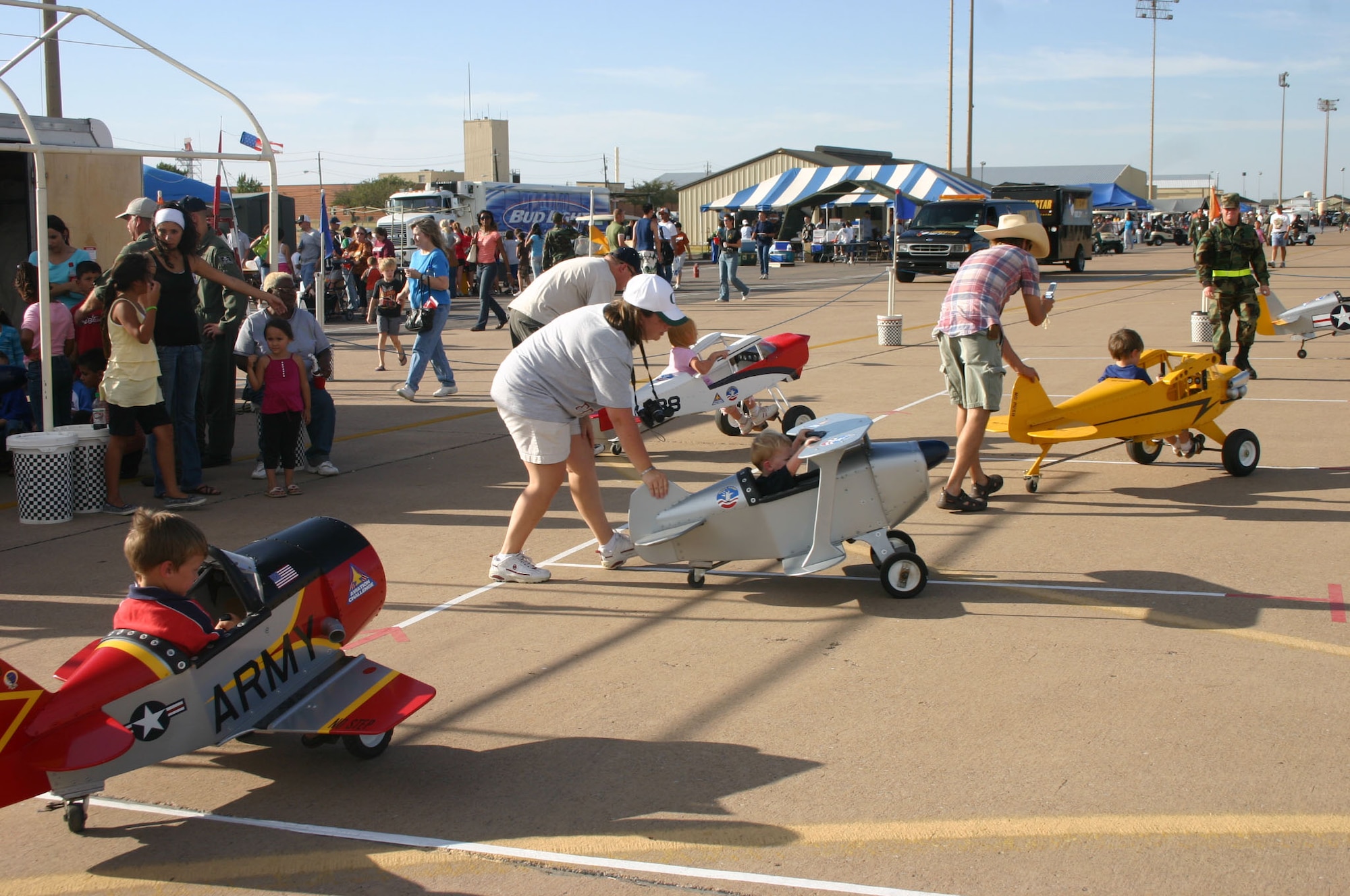 Parents help their children line up along the runway and prepare for takeoff at the Sheppard Open House and Air Show Oct. 20.  The ground attraction was offered by the Stepping Stones to Aviation organization. (U.S. Air Force photo/Staff Sgt. Tonnette Thompson)