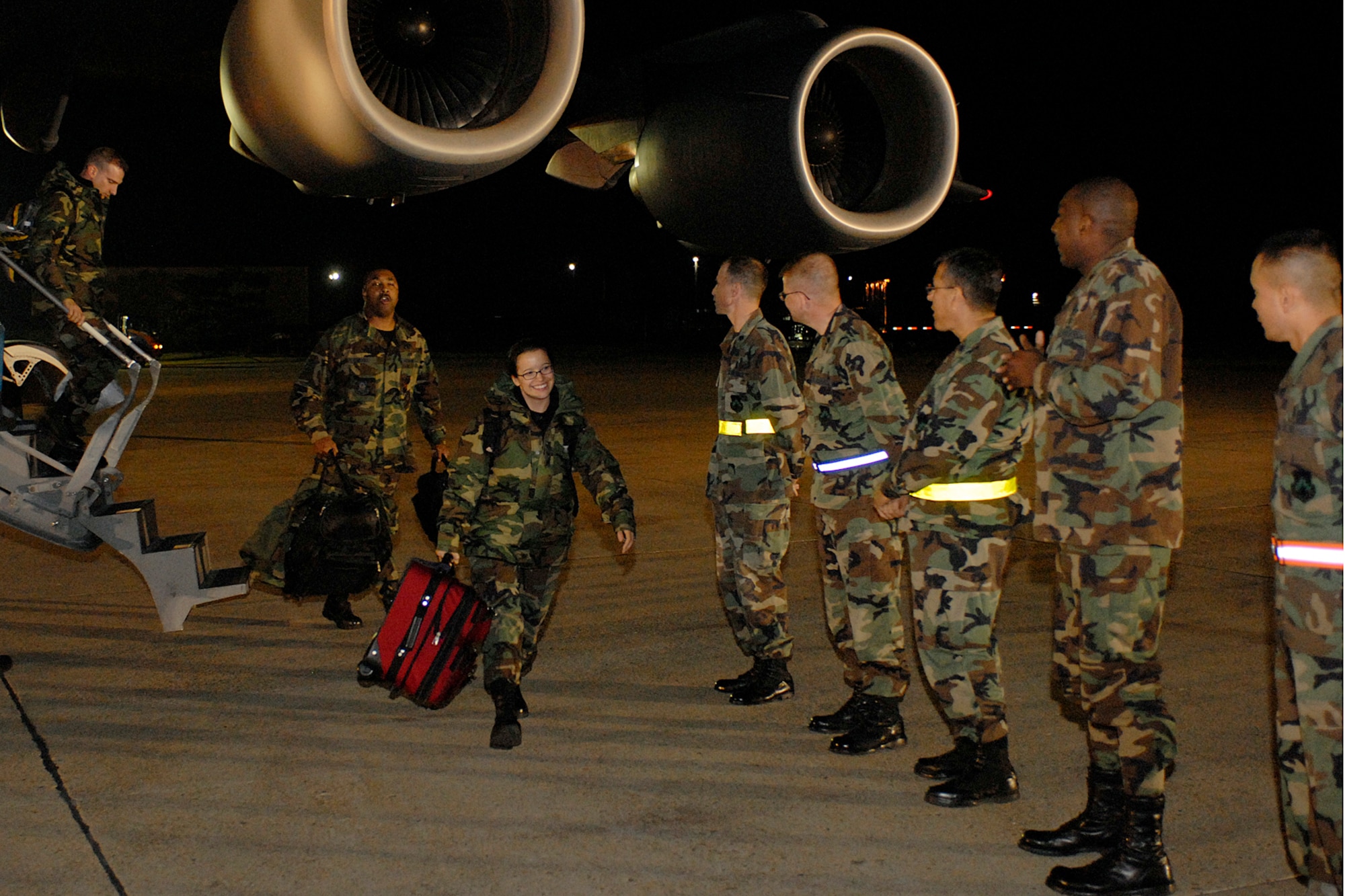 KUNSAN AIR BASE, South Korea -- Members of the Wolf Pack form a welcome line to greet arriving Airman from the 944th Medical Squadron, Air Force Reserve, Oct. 23 here. The deployment of Reserve unit from Luke AFB, Ariz., is to build up an Expeditionary Medical System (EMEDS) +25 Theater Hospital. (U.S. Air Force photo/Senior Airman Giang Nguyen)
