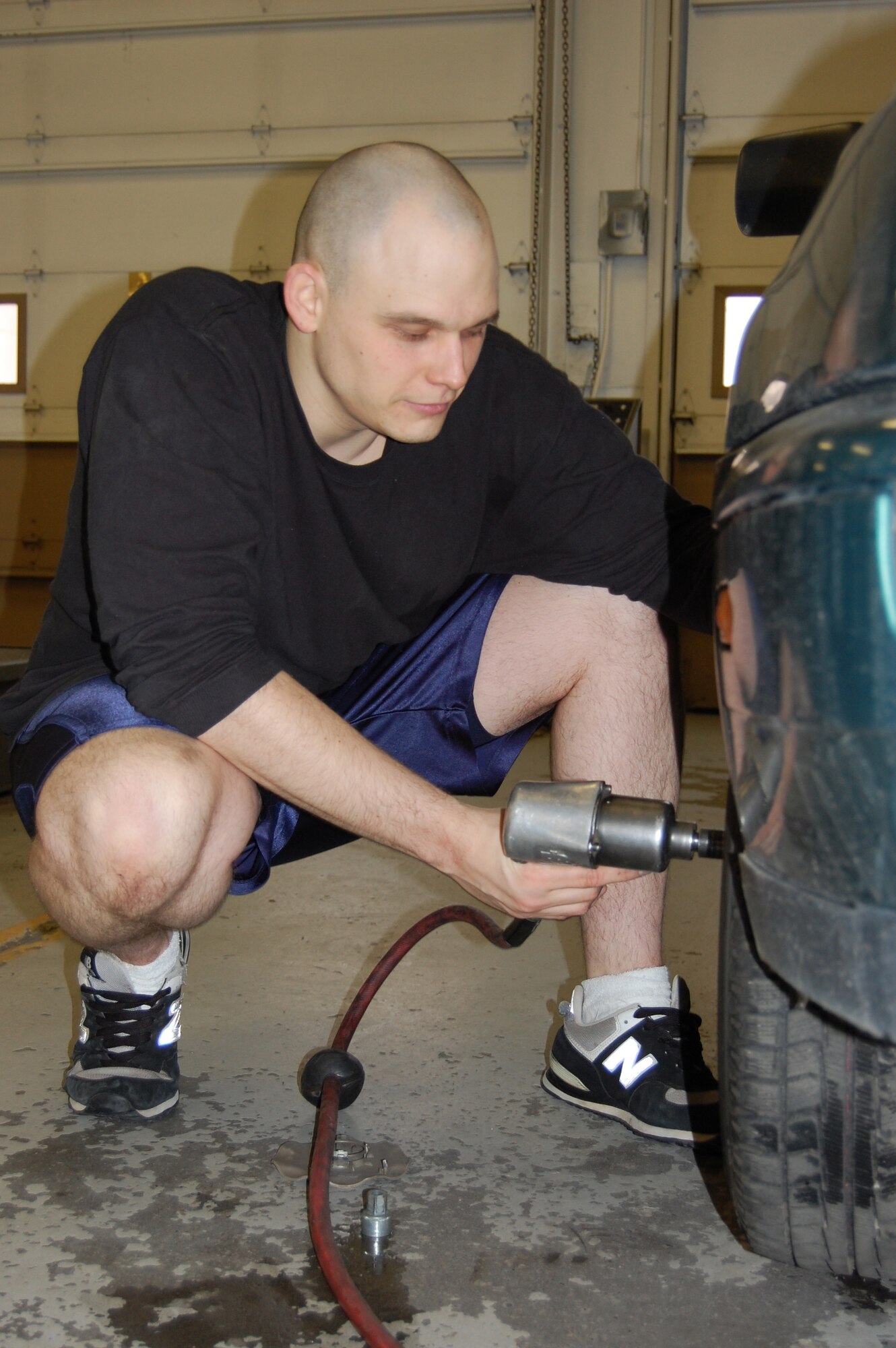 EIELSON AIR FORCE BASE, Alaska--Senior Airman Eric Webb, 354th Logistics Readniss Squadron fuels resource controller, replaces a regular tire with a snow tire Oct. 23 at the Auto Skills Center. Auto Skills Center Staff routinely assist spouses of deployed servicemembers around housing by doing routine maintenance checks. The center also has a car dolly to be used in emergencies on and off base. For more information, call 377-3190. (U.S. Air Force photo by Airman 1st Class Nora Anton)