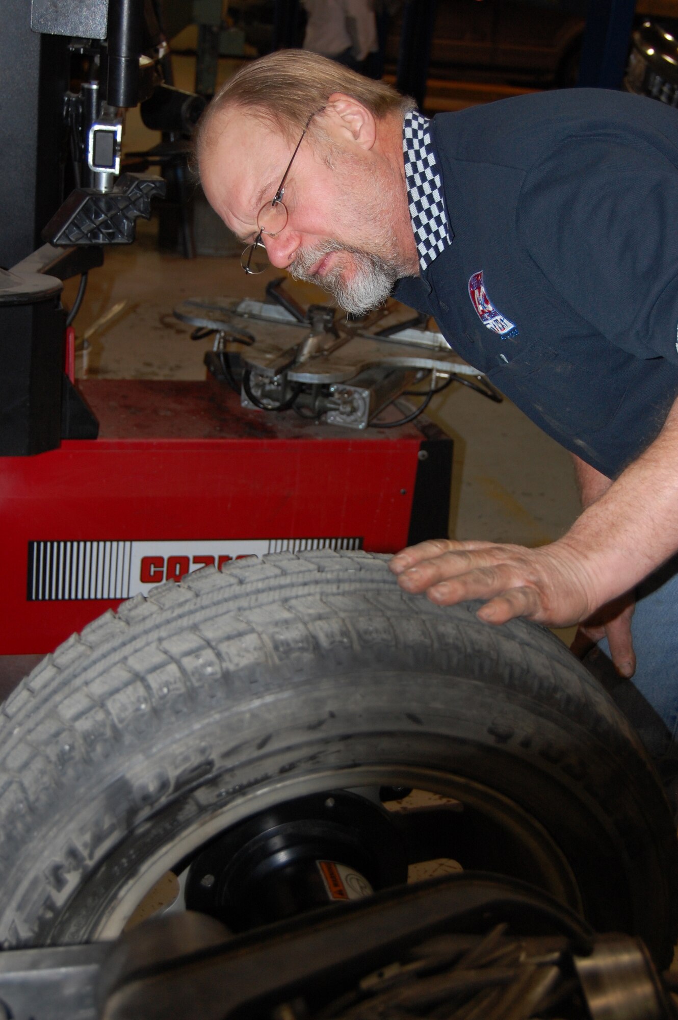EIELSON AIR FORCE BASE, Alaska--Rick Bertz, Auto Skills Center manager, checks for tire size before inputting data into the tire balance machine Oct. 23 at the Auto Skills Center. For more information on the Auto Skills Center, call 377-3190. (U.S. Air Force photo by Airman 1st Class Nora Anton)