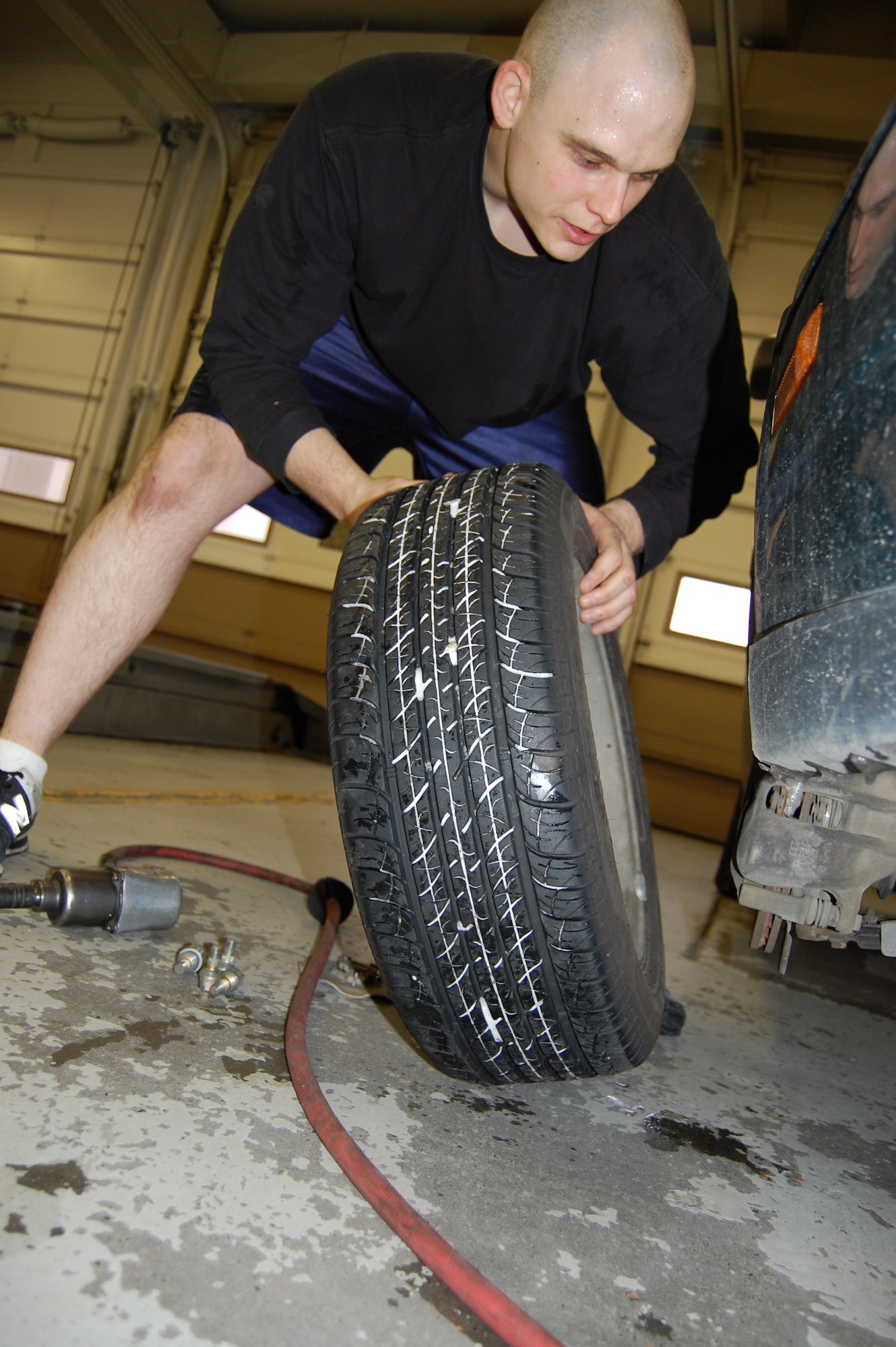 EIELSON AIR FORCE BASE, Alaska--Senior Airman Eric Webb, 354th Logistics Readiness Squadron fuels resource controller, removes regular tires while switching them out for snow tires Oct. 23 at the Auto Skills Center. The Auto Skills Center staff will assist in switching out tires for an average of $7 to $10 per tire, depending on the type and size, and charges $4.50 per hour to rent out a workspace in the garage. The shop will help switch out more than 1,000 regular tires for snow tires this month alone. (U.S. Air Force photo by Airman 1st Class Nora Anton)