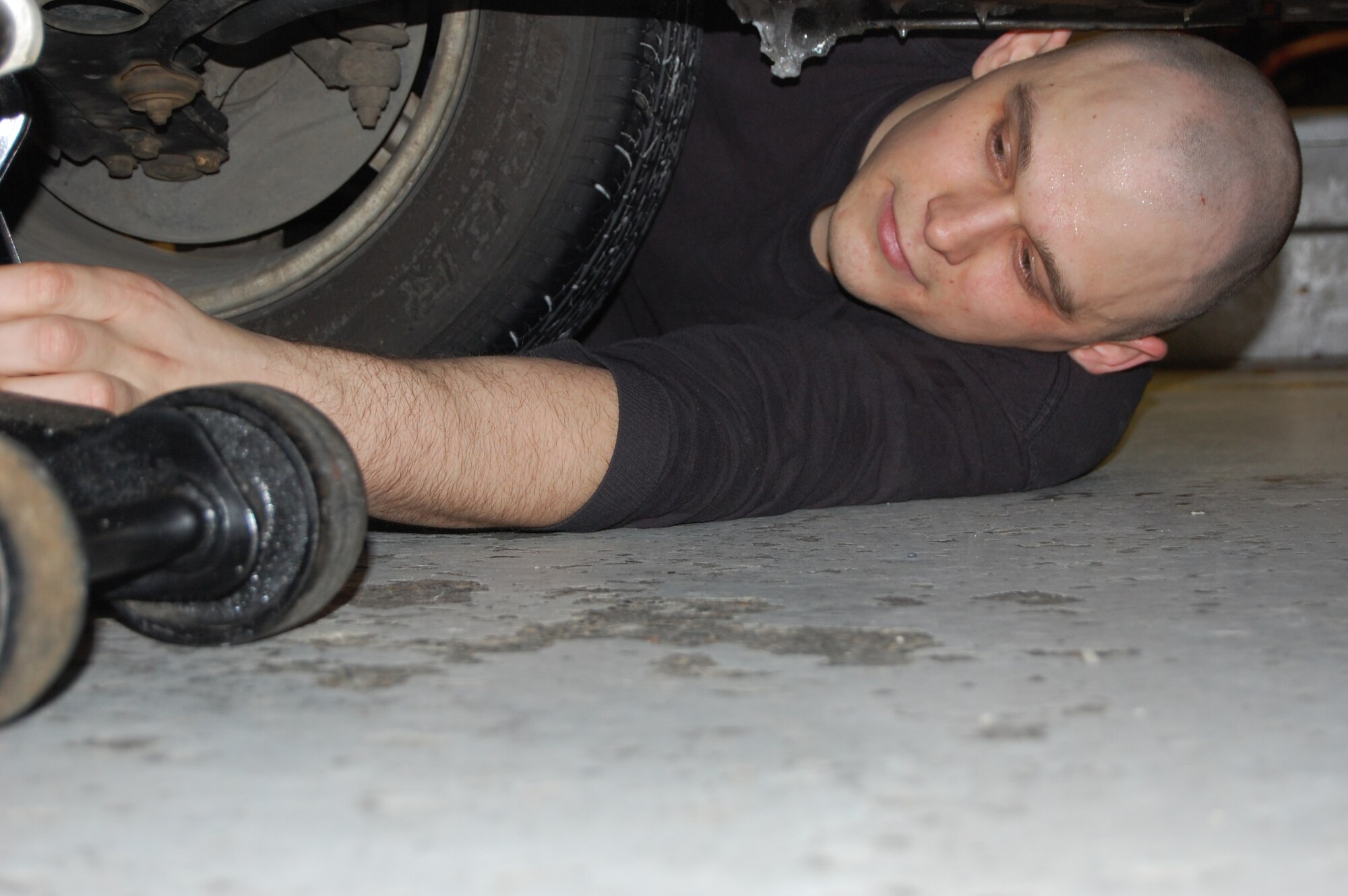 EIELSON AIR FORCE BASE, Alaska--Senior Airman Eric Webb, 354th Logistics Readiness Squadron fuels resource controller, jacks a car up to change out regular tires for snow tires Oct. 23 at the Auto Skills Center. The auto hobby shop offers do-it-yourself resources for car maintenance such as providing tools and if needed, assistance in auto projects. (U.S. Air Force photo by Airman 1st Class Nora Anton)