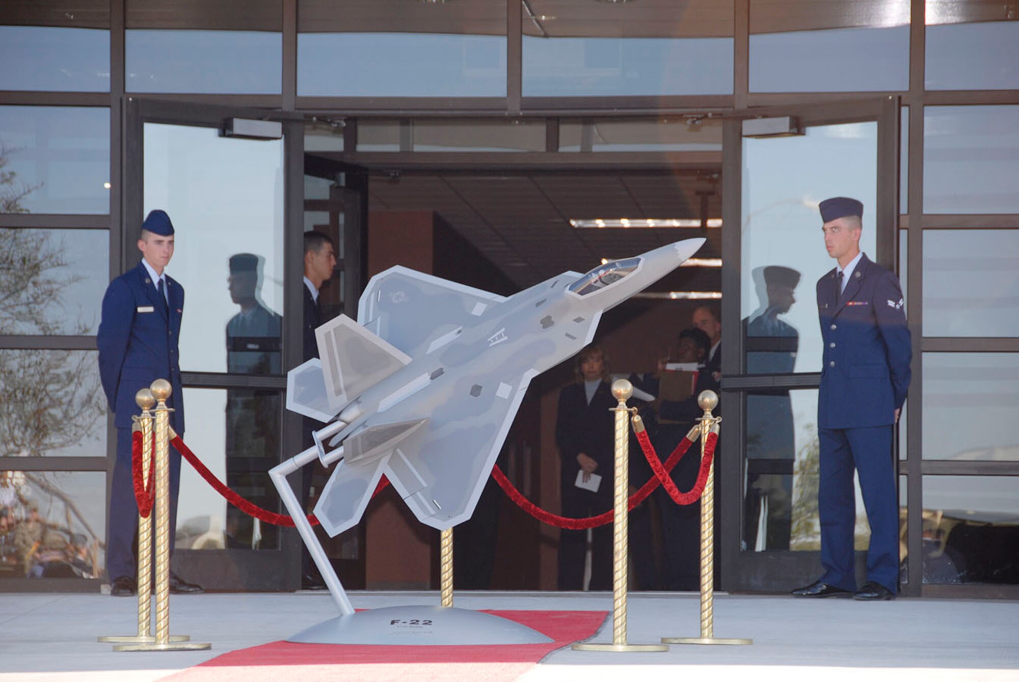 Airmen in Training stand outside the newly opened F-22 Raptor Maintenance Training Facility Oct. 19. Come January 2008 the facility will train the second generation of Raptor maintaners for the Air Force. (U.S. Air Force photo/Sandy Wassenmiller)