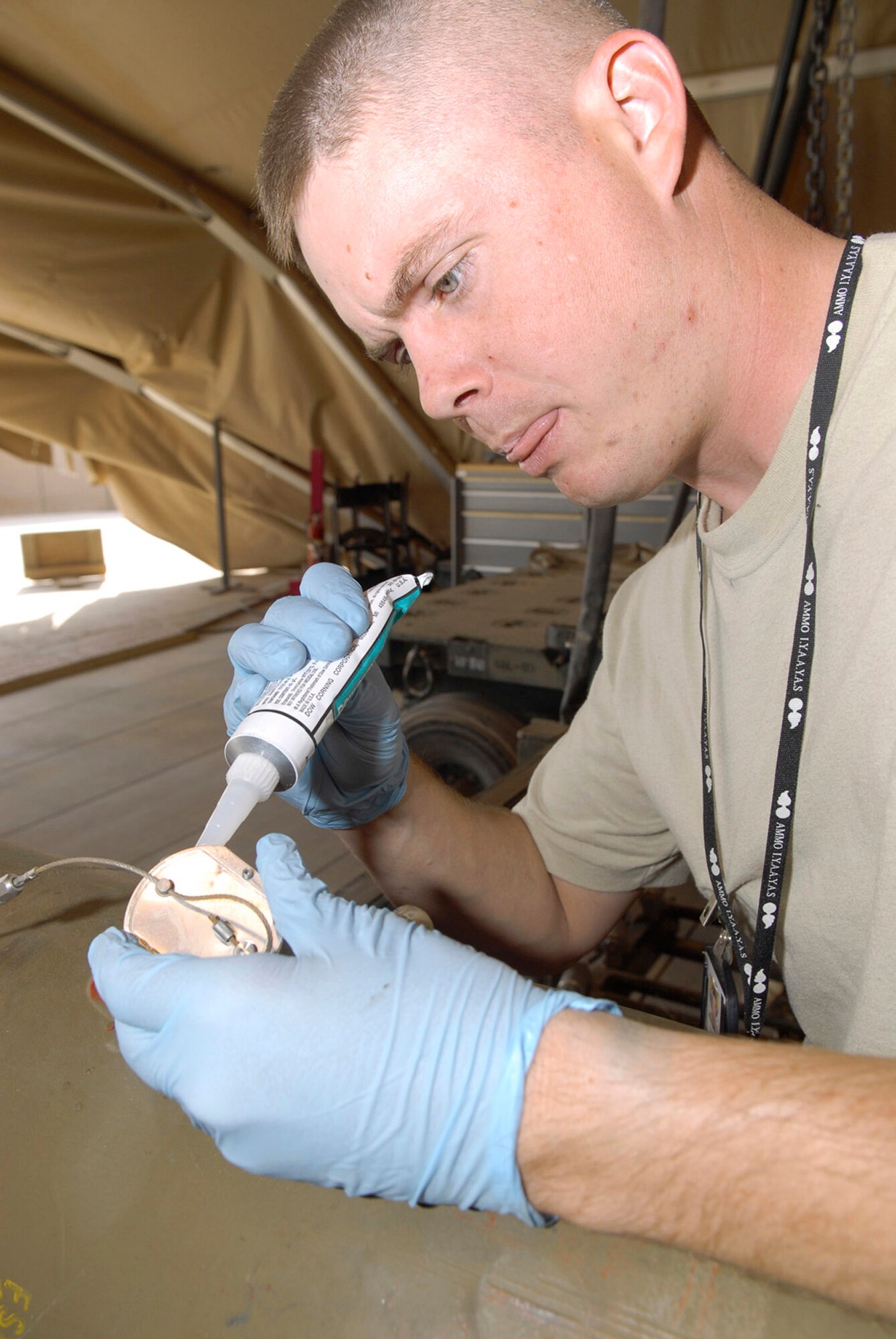 Staff Sgt. Zack Casagranda uses sealant compound as he builds a joint direct attack munition Oct. 15 at Balad Air Base, Iraq. The sealant prevents dirt from getting inside the bomb. Sergeant Casagranda's home station is Hill Air Force Base, Utah. He is assigned to the 332nd Expeditionary Maintenance Squadron. (U.S. Air Force photo/Staff Sgt. Joshua Garcia) 
