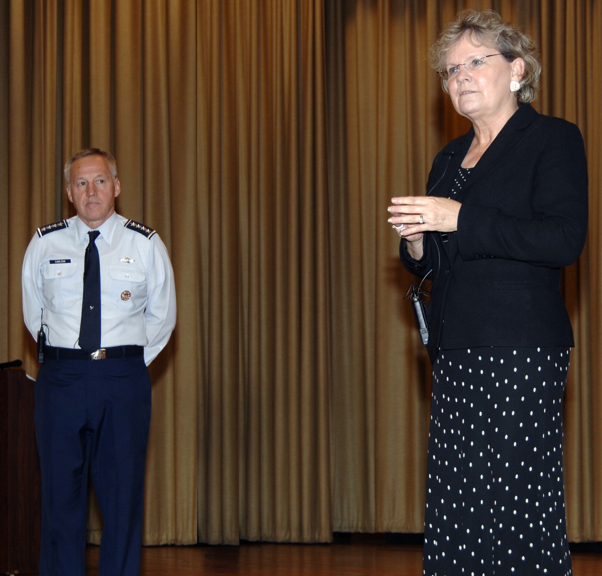Assistant Secretary of the Air Force for Acquisition Sue Payton listens to a question from an attendee at a joint commander’s call held Oct. 19 in the base theater at Wright-Patterson Air Force Base, Ohio. Ms. Payton, along with Gen. Bruce Carlson, AFMC commander (left), used the event to discuss a new partnership to overcome weapon-system acquisition challenges. (Air Force photo by Al Bright)