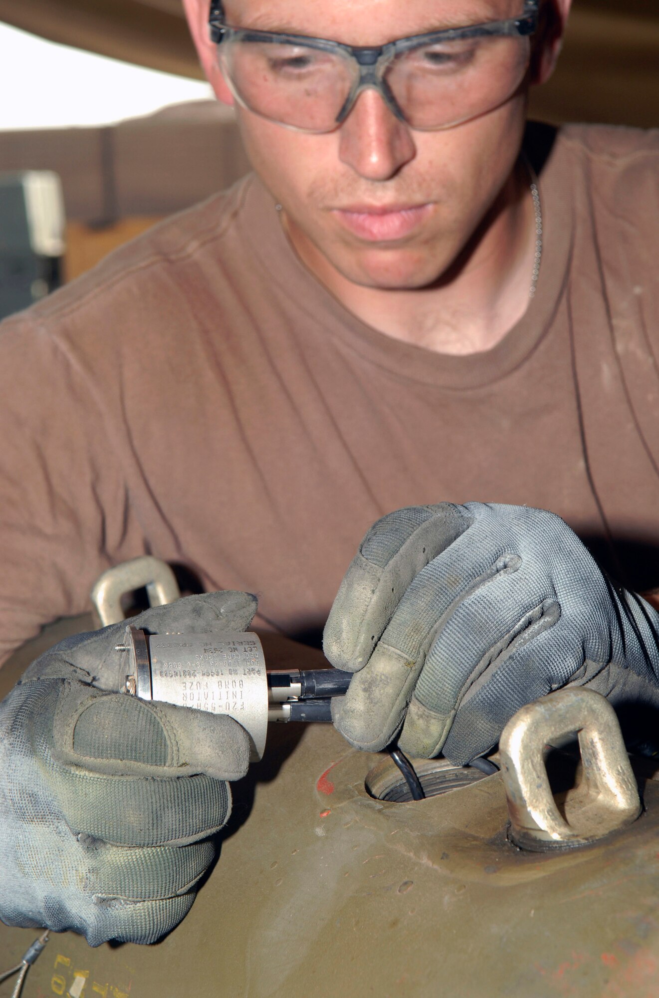 Staff Sgt. Travis Tarr connects a proximity sensor as he builds a joint direct attack munition Oct. 15 at Balad Air Base, Iraq. The proximity sensor allows the bomb to explode prior to coming in contact with the ground. Sergeant Tarr is deployed from Spangdahlem Air Base, Germany. He is assigned to the 332nd Expeditionary Maintenance Squadron. (U.S. Air Force photo/Staff Sgt. Joshua Garcia) 
