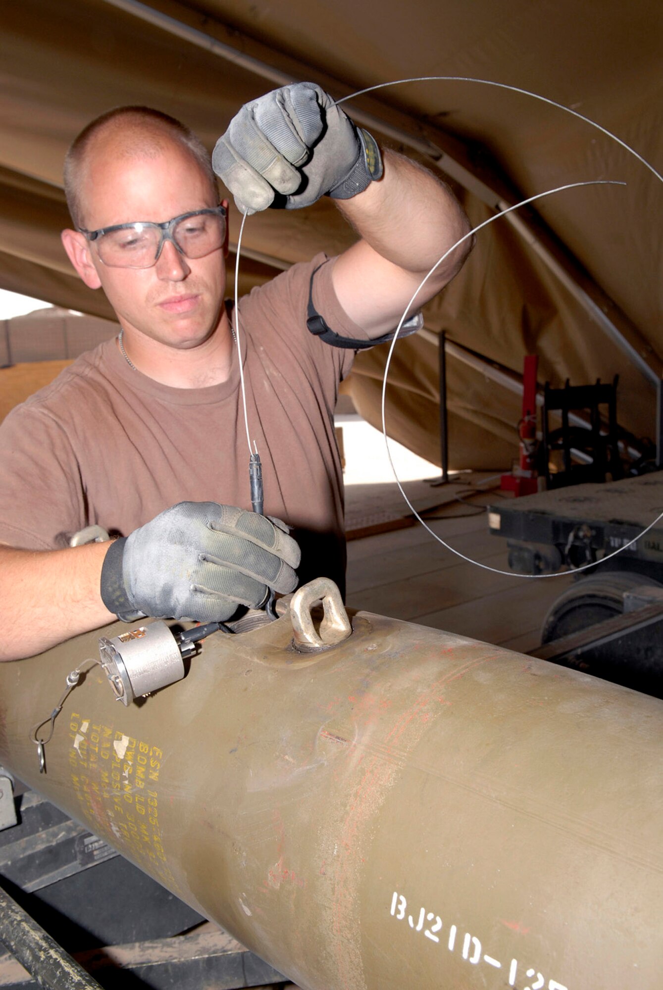 Staff Sgt. Travis Tarr works on a joint direct attack munition Oct. 15 at Balad Air Base, Iraq. The guided bomb unit-38 JDAM is used with the F-16 Fighting Falcon and is designed to explode above ground. Sergeant Tarr is deployed from Spangdahlem Air Base, Germany. He is assigned to the 332nd Expeditionary Maintenance Squadron. (U.S. Air Force photo/Staff Sgt. Joshua Garcia) 
