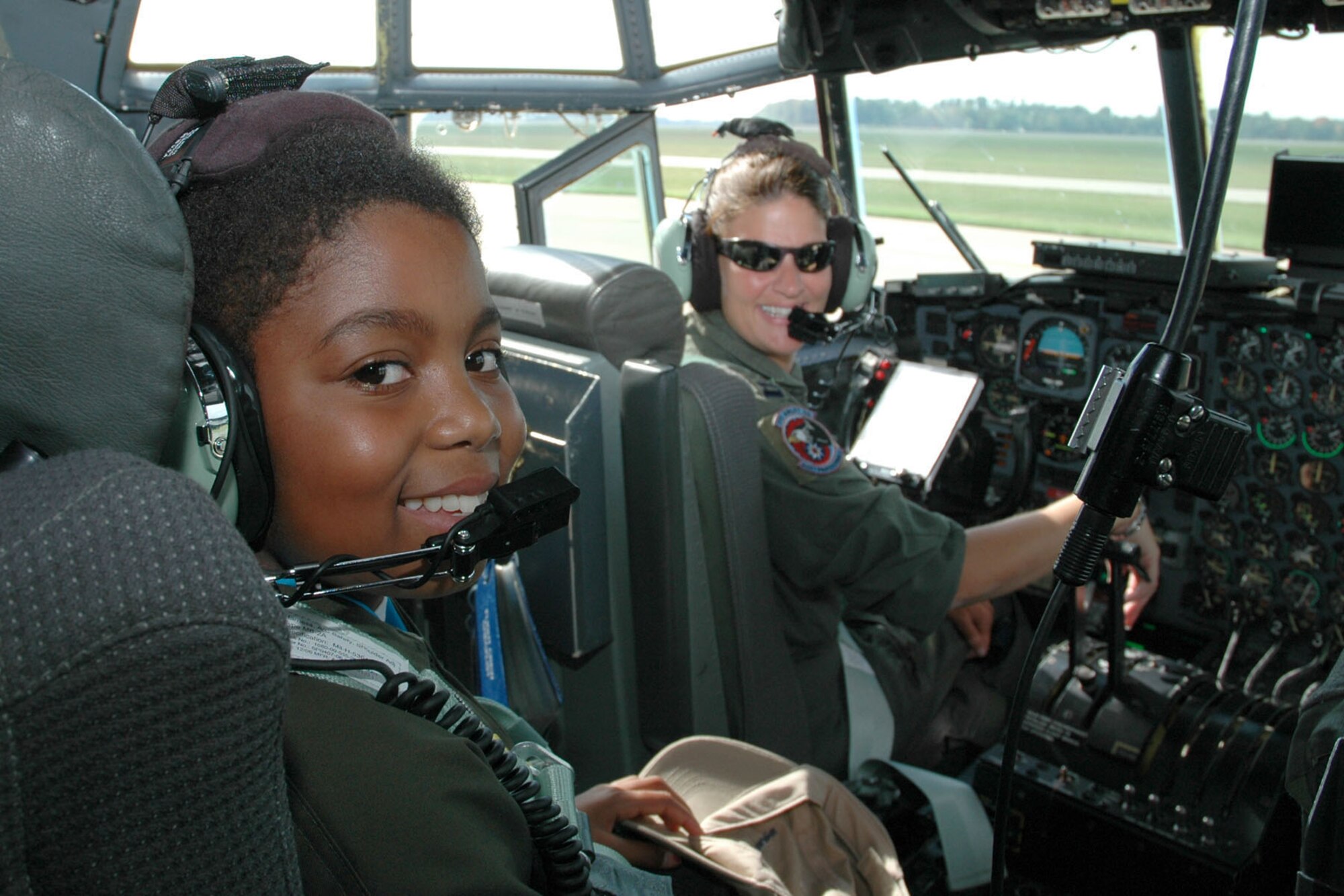 YOUNGSTOWN AIR RESERVE STATION, Ohio — Air Force Reserve Honorary 2nd Lt. Darian Hammond, strapped into the navigator's chair of a C-130 assigned to the 910th Airlift Wing looks back as she talks with aircraft commander, Capt. Michele Mollise (right) in preparation for a high-speed taxi as part of the 910th's Pilot for a Day program activities held here. U.S. Air Force photo/Tech. Sgt. Bob Barko Jr.