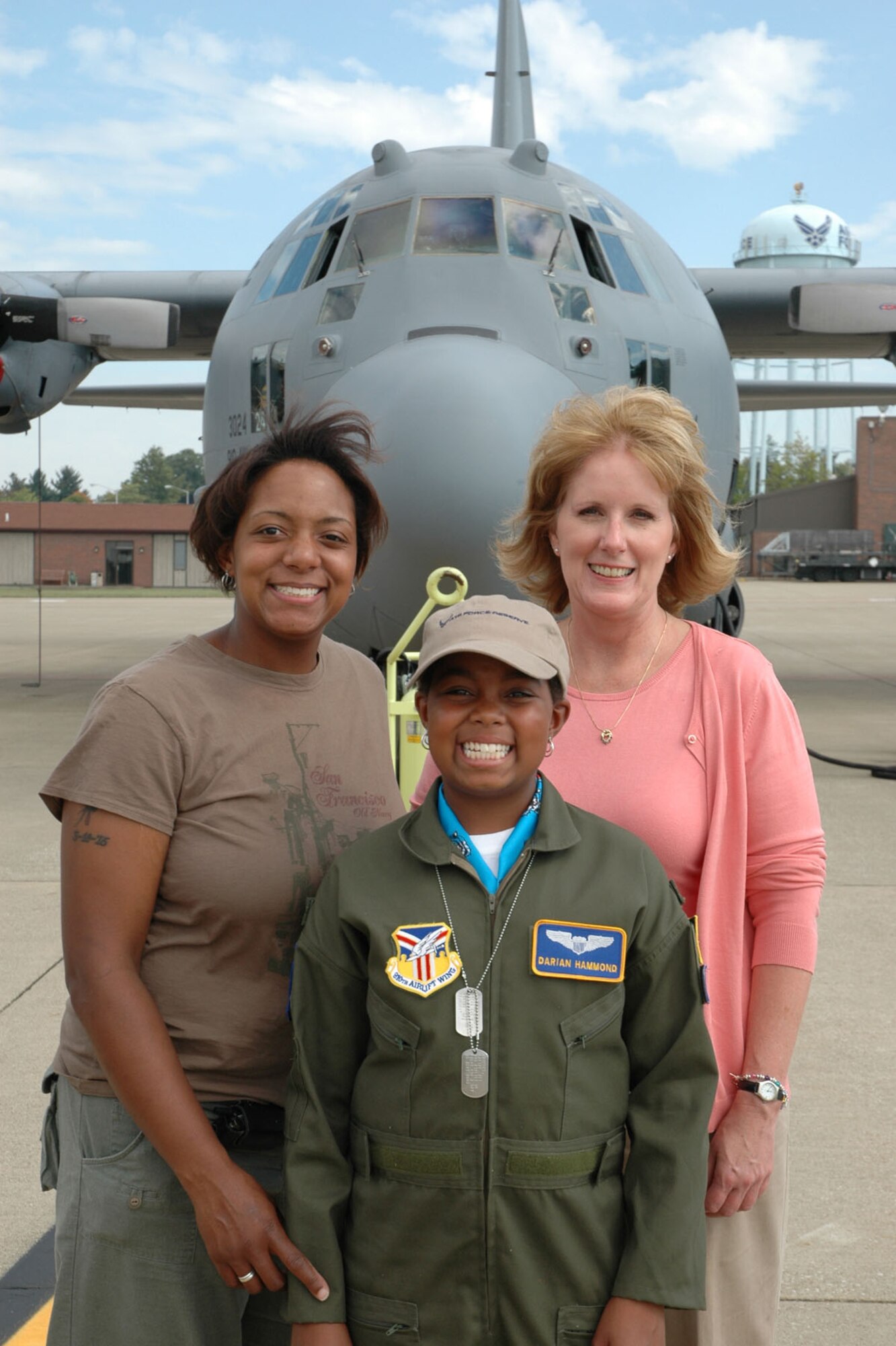 YOUNGSTOWN AIR RESERVE STATION, Ohio — Air Force Reserve Honorary 2nd Lt. Darian Hammond stands in front of a C-130 on the flight line as part of her base orientation during the 30th Pilot for a Day program event held here. Pictured with Lieutenant Hammond are her mother, Shaquita Hammond (left) and Carole Wehmeyer of Akron's Children's Hospital. Lieutenant Hammond is undergoing treatment for leukemia at the hospital's annex at St. Elizabeth Health Center in Youngstown. U.S. Air Force photo/Tech. Sgt. Bob Barko Jr. 