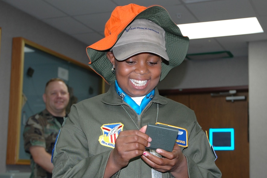 YOUNGSTOWN AIR RESERVE STATION, Ohio — Air Force Reserve Honorary 2nd Lt. Darian Hammond, Pilot for a Day, checks out a camoflauge paint kit and a survival hat given to her by the 757th Airlift Squadron Life Support section here as Capt. Brent Davis, 910th Airlift Wing Public Affairs Officer looks on. U.S. Air Force photo/Tech. Sgt. Bob Barko Jr.