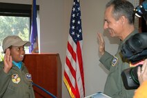 YOUNGSTOWN AIR RESERVE STATION, Ohio — Darian Hammond, 9, takes the oath commissioning her as an honorary second leiutenant from Col. Karl McGregor, commander of the 910th Airlift Wing, at the Wing Headquarters building here, as part of the unit's Pilot for a Day program. She was diagnosed with leukemia in 2006 and is the 30th child to particpate in the outreach program that provides a base tour and orientation for children who have life-threatening or chronic illnesses. Local media was on hand to capture the ceremony that started the day-long program actvities. U.S. Air Force photo/ Tech. Sgt. Bob Barko Jr.