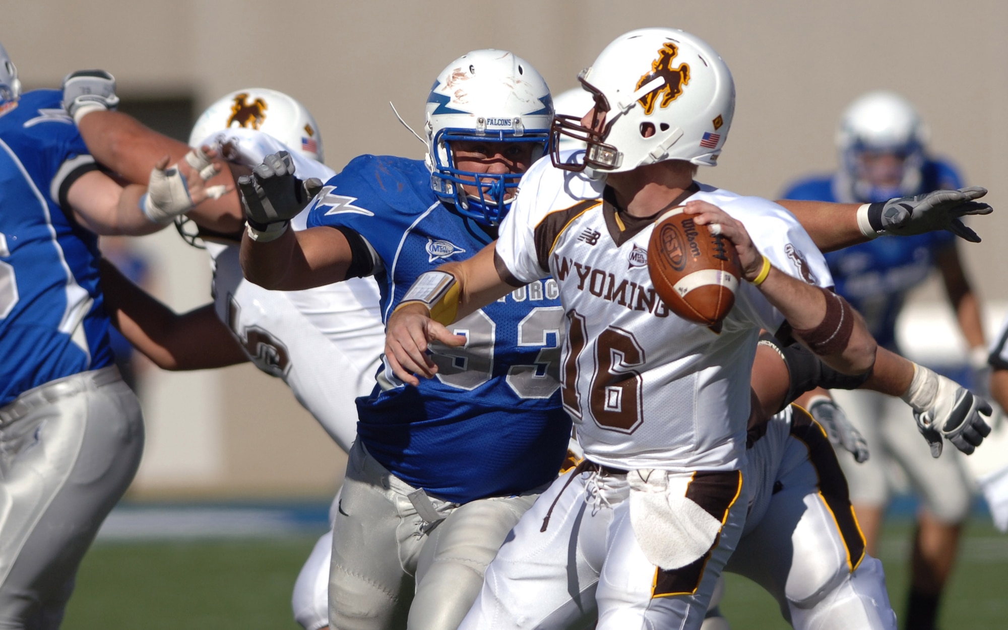 U.S. Air Force Academy Falcons nose guard Ben Garland pressures Wyoming quarterback Karsten Sween during Air Force's 20-12 win Oct. 20 at Falcon Stadium in Colorado. The Air Force defense sacked Sween twice and forced him to throw three interceptions. (U.S. Air Force photo/Dave Armer) 
