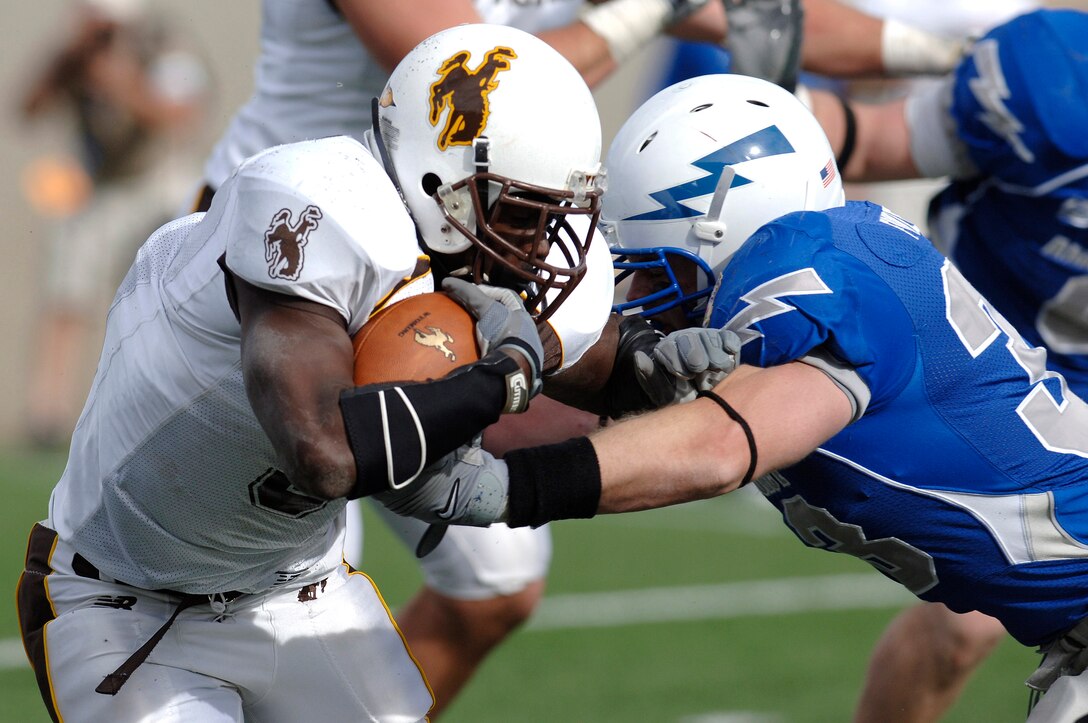 U.S. Air Force Academy Falcons linebacker Drew Fowler goes one-on-one with Wyoming running back Wynel Seldon during Air Force's 20-12 win Oct. 20 at Falcon Stadium in Colorado. Fowler had 12 tackles in the game, his 12th career game in double figure tackles. (U.S. Air Force photo/Mike Kaplan) 