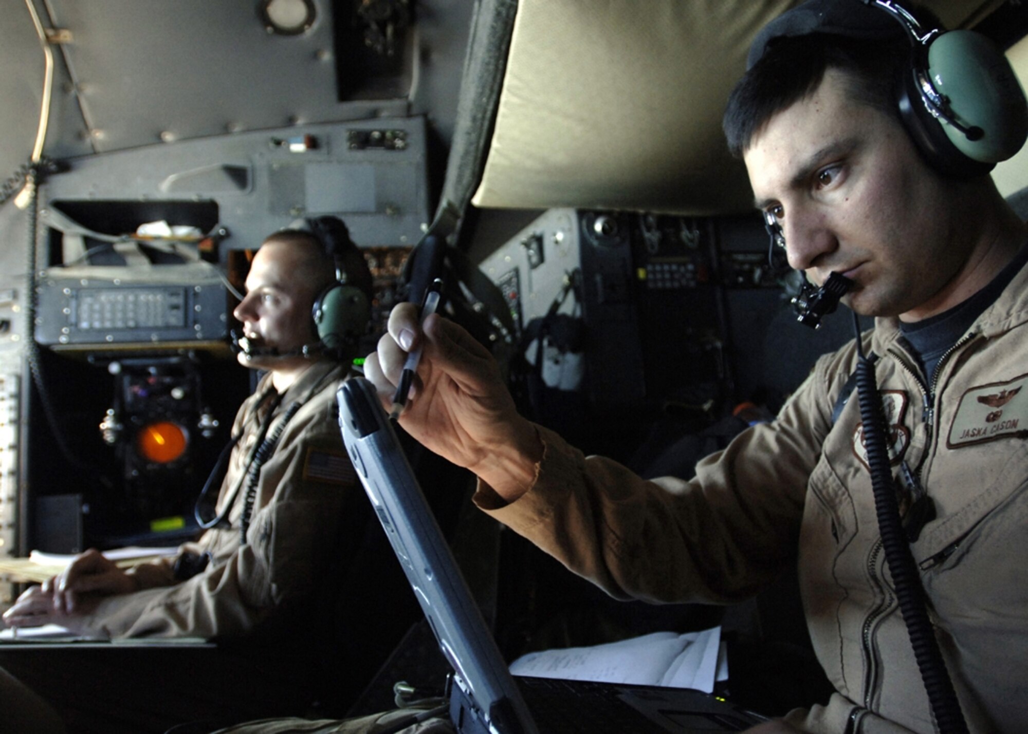 AFGHANISTAN -- U.S. Air Force Maj. Jaska Cason, C-130 Hercules aircraft mission commander, calculates, coordinates and prepares his crew before dropping 30,000 warning leaflets over the southeastern mountains of Afghanistan.  The leaflets were used to communicate with Taliban extremists, warning them not to interfere with Coalition activities.  The leaflet airdrop mission is helping to create an environment that will enable the government of Afghanistan to help improve security and the Afghan people's quality of life.  (U.S. Air Force photo by Tech. Sgt. Cecilio Ricardo, Released)