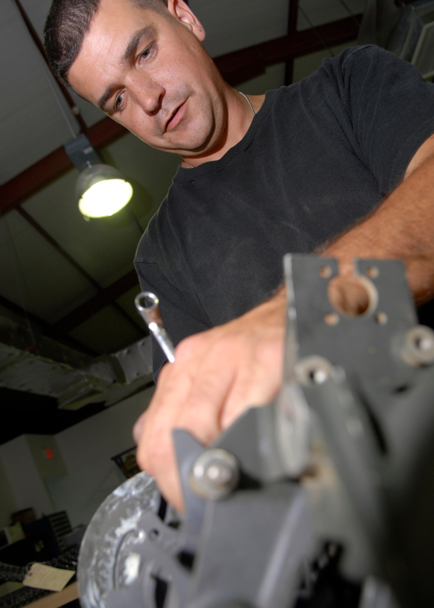 Tech. Sgt. Michael Dixon performs preventive maintenance Oct. 22 on a universal ammunition loading system in his maintenance shop at Balad Air Base, Iraq.  Sergeant Dixon is deployed from the Indiana Air National Guard's 122nd Fighter Wing in Ft. Wayne. He is assigned to the 332nd Expeditionary Maintenance Squadron. (U.S. Air Force photo/Staff Sgt. Joshua Garcia)