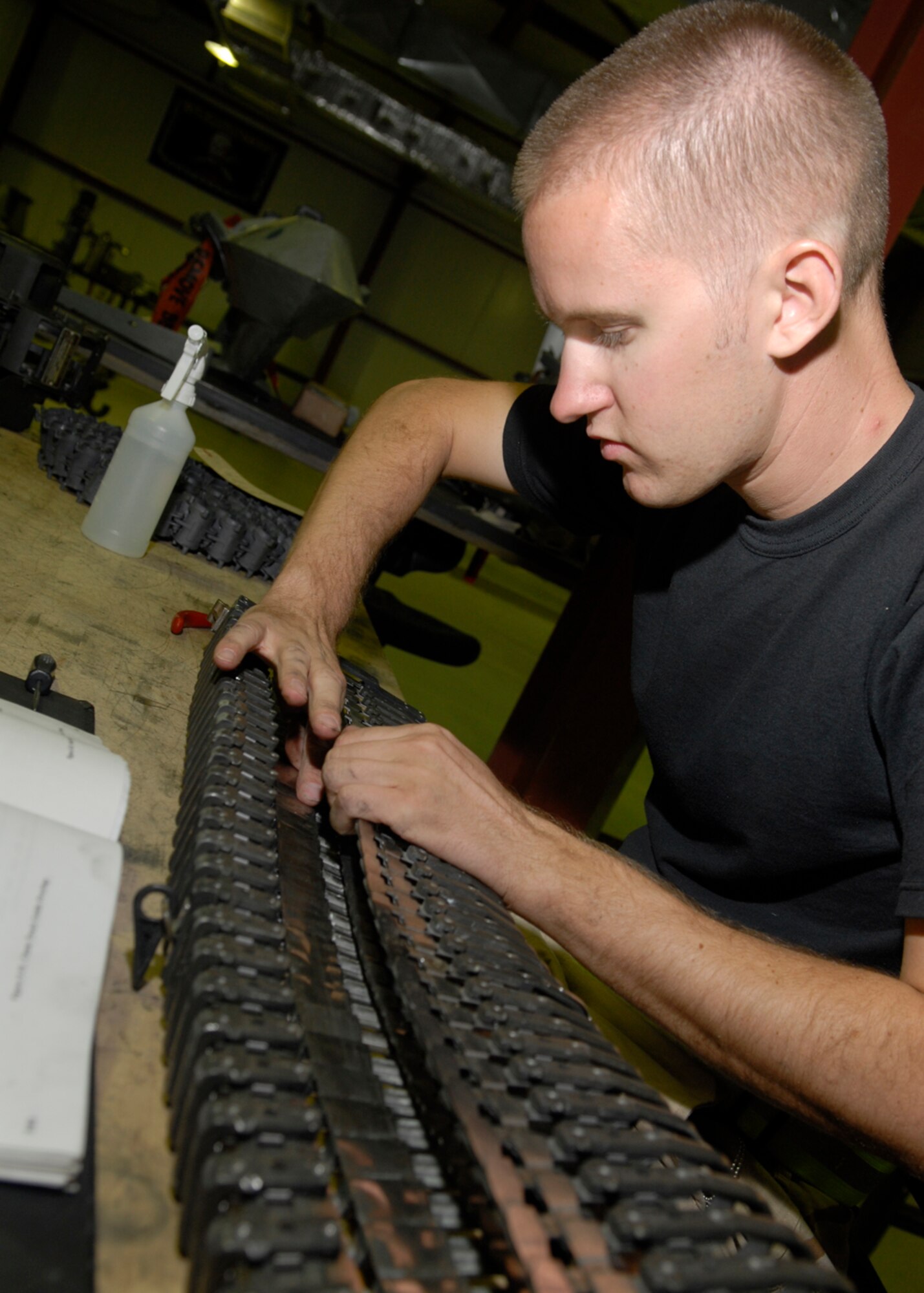 Staff Sgt. Alec Cawlfield repairs a damaged section of the feed chute of a universal ammunition loading system Oct. 22 in his maintenance shop at Balad Air Base, Iraq. The feed chute is used to load the bullets into the aircraft. Sergeant Cawlfield is deployed from the Indiana Air National Guard's 122nd Fighter Wing in Ft. Wayne. He is assigned to the 332nd Expeditionary Maintenance Squadron. (U.S. Air Force photo/Staff Sgt. Joshua Garcia)