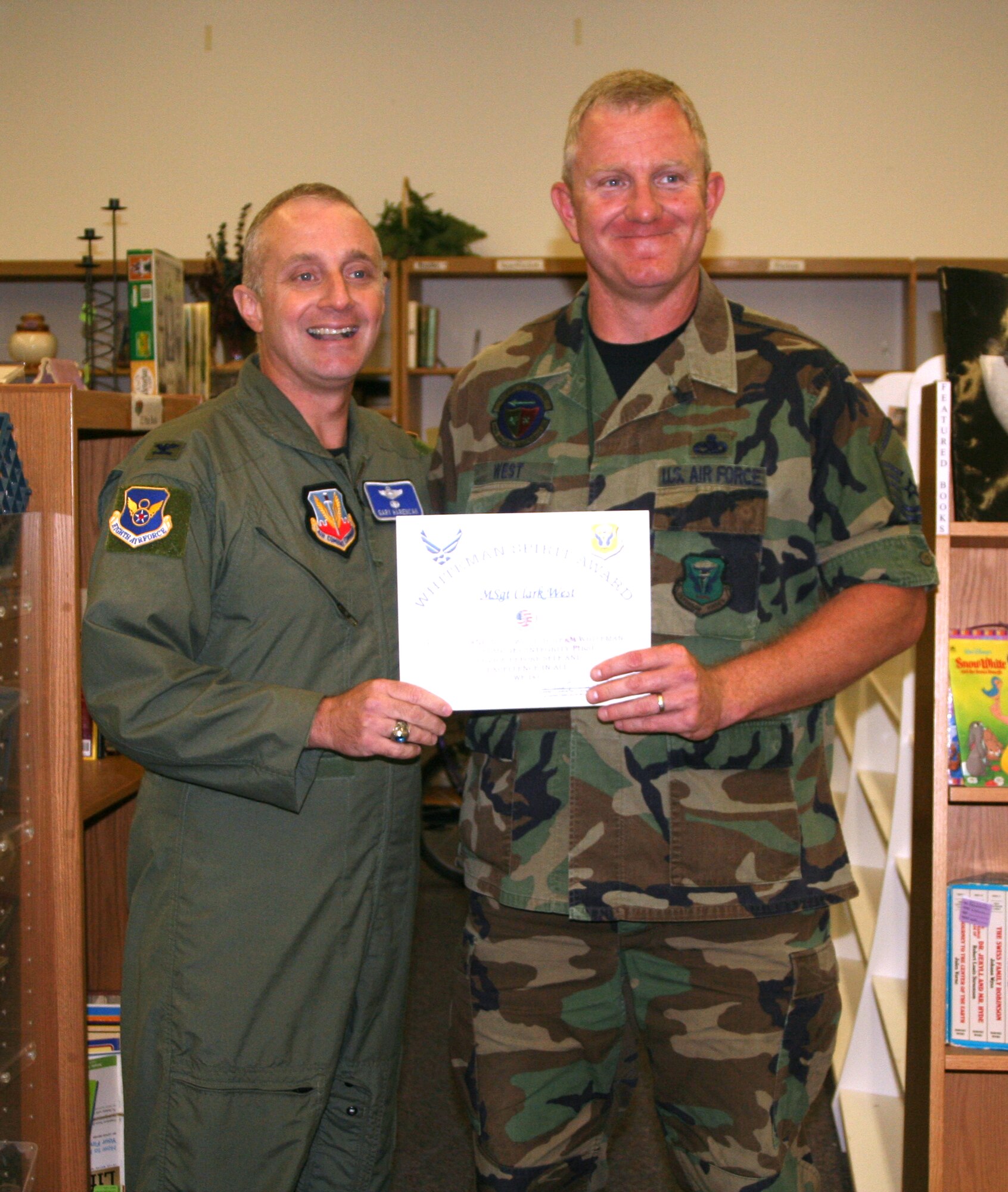 Left to right: Col. Garrett Harencak, 509th Bomb Wing commander, presents the Whiteman Spirit Award to Master Sgt. Clark West, 509th Aircraft Maintenance Squadron, Oct. 22. (U.S. Air Force photo/1st Lt. Candace Cutrufo)