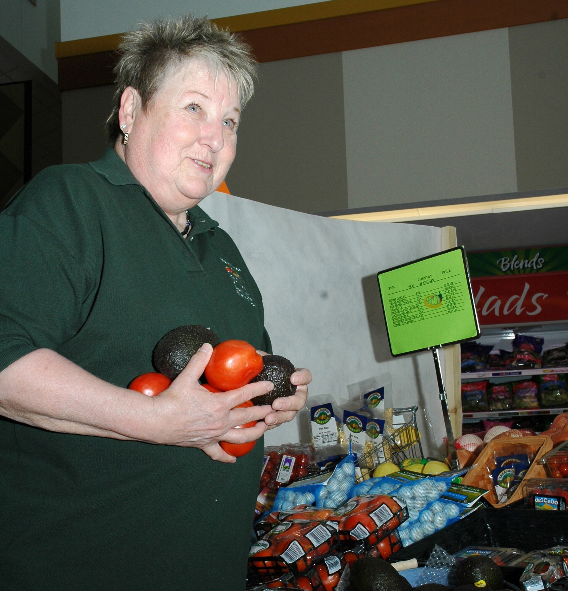 Dolly Wojciechowski, commissary produce worker, sorts through vegetables at the commissary. Ms. Wojciechowski crocheted a breast cancer awareness blanket to serve as a door prize for Ladies Night at the Health and Wellness Center. Ladies Night at the HAWC is an event focusing on women's health, as well as breast cancer awareness..  (U.S. Air Force photo/Airman 1st Class Emerald Ralston)