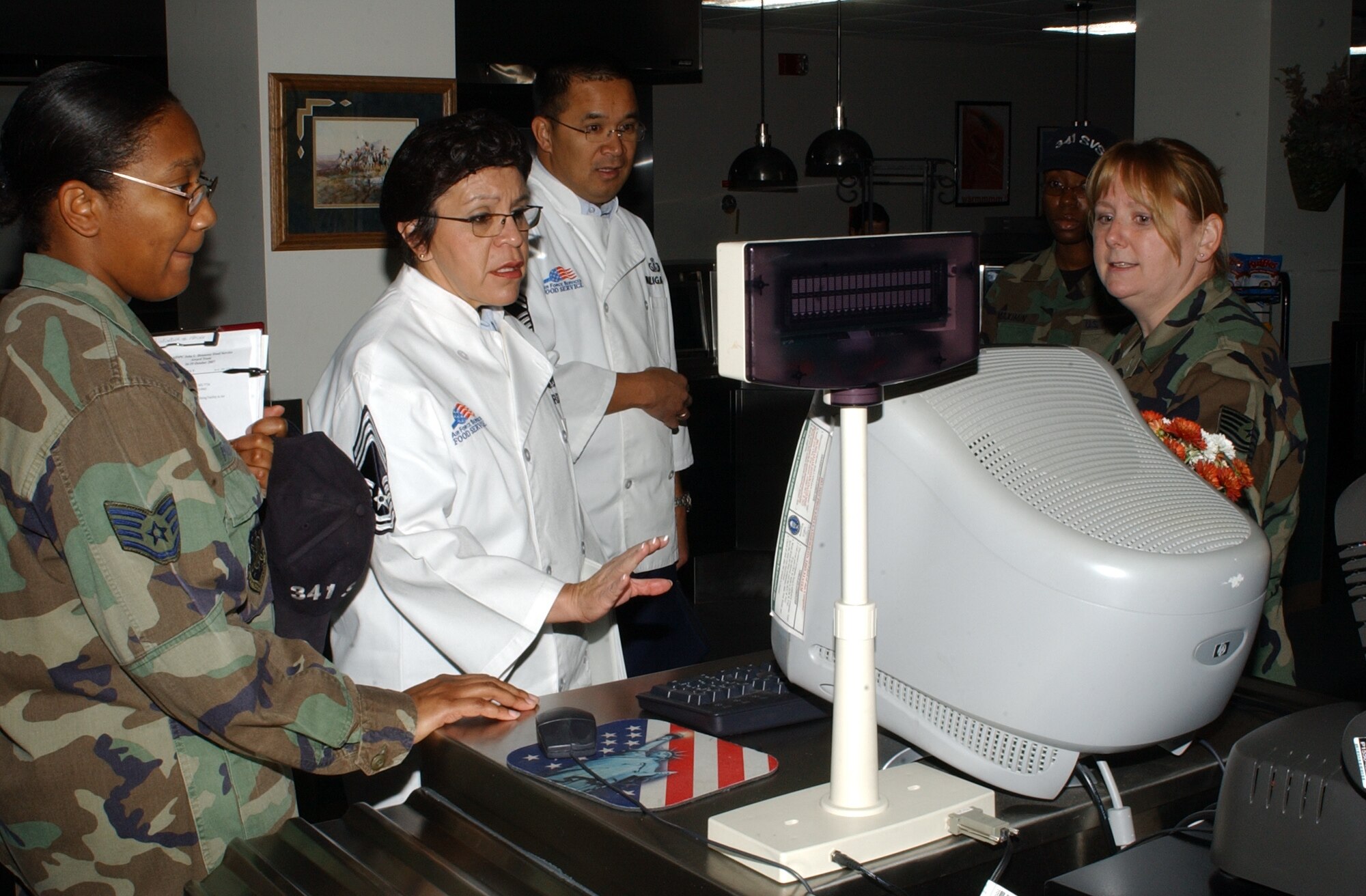 Chief Master Sgt. Bernadette Borders, Headquarters Air Force Space Command Services chief enlisted manager, asks Tech. Sgt. Lisa Schutz, Elkhorn Dining Facility manager, right, about the food options available to patrons as part of a two-day evaluation at Malmstrom Oct. 16 to 17. The 341st Services Squadron dining facility is competing against AFSPC bases to determine who will represent the command at the annual Hennessy Award Program competition. Established in 1956, the program determines which dining facility will have bragging rights for being the best food service program in the Air Force. (U.S. Air Force photo/Staff Sgt. Marcus McDonald)