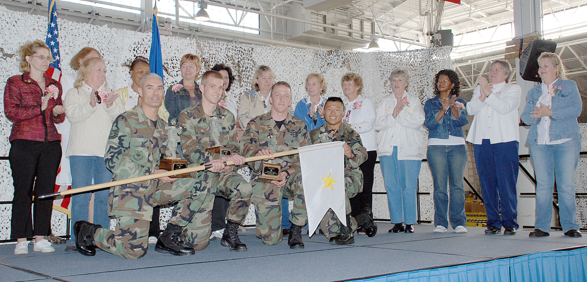 The winners of the Inaugural McGuire AFB Ruck March are recognized, with the GSM flag, along with the Gold Star Mothers after the march here Oct. 20. The team finished the six-mile ruck in 1:07:12.  (U.S. Air Force photo / Airman 1st Class Rebekah Phy)
