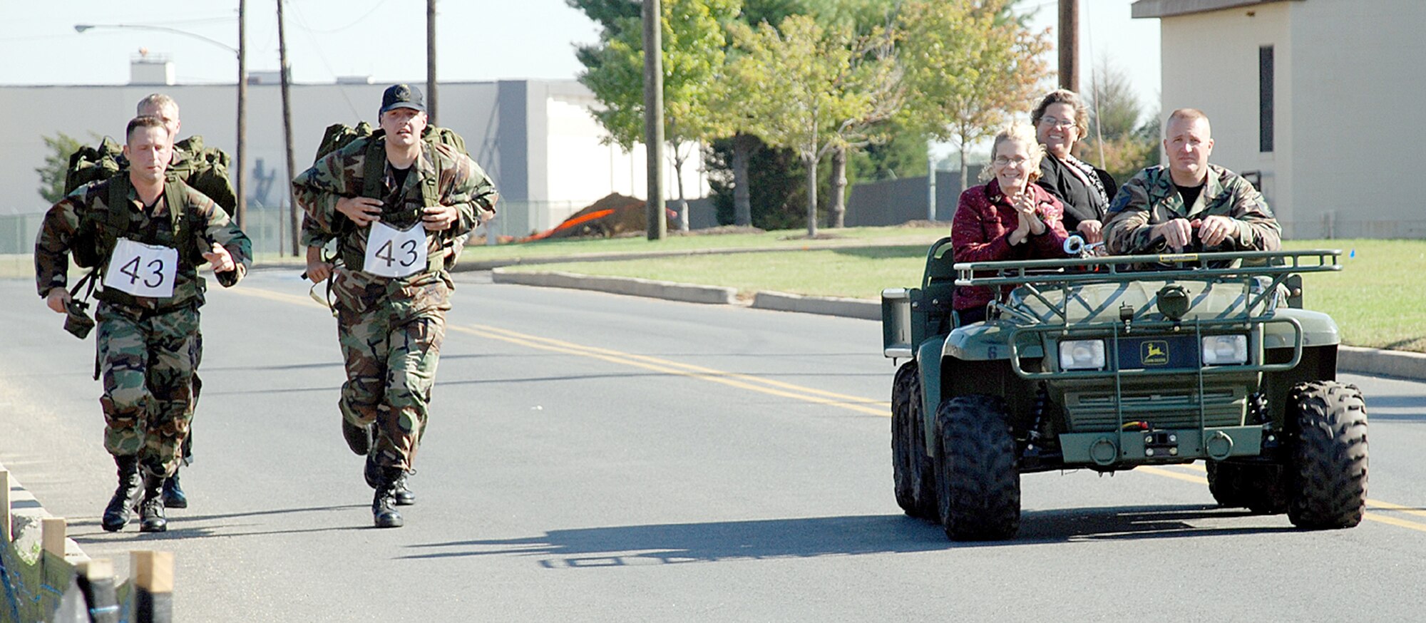 Gold Star Mother Kimberly Geonnotti, front, and her sister, Elle Bentz, ride with Master Sgt. Edward Malkowski, 817th Contingency Response Group first sergeant, to help cheer on participants in the Inaugural McGuire AFB Ruck March here Oct. 20. The Gold Star Mothers were honored with breakfast and the six-mile ruck march.  (U.S. Air Force photo / Airman 1st Class Rebekah Phy)