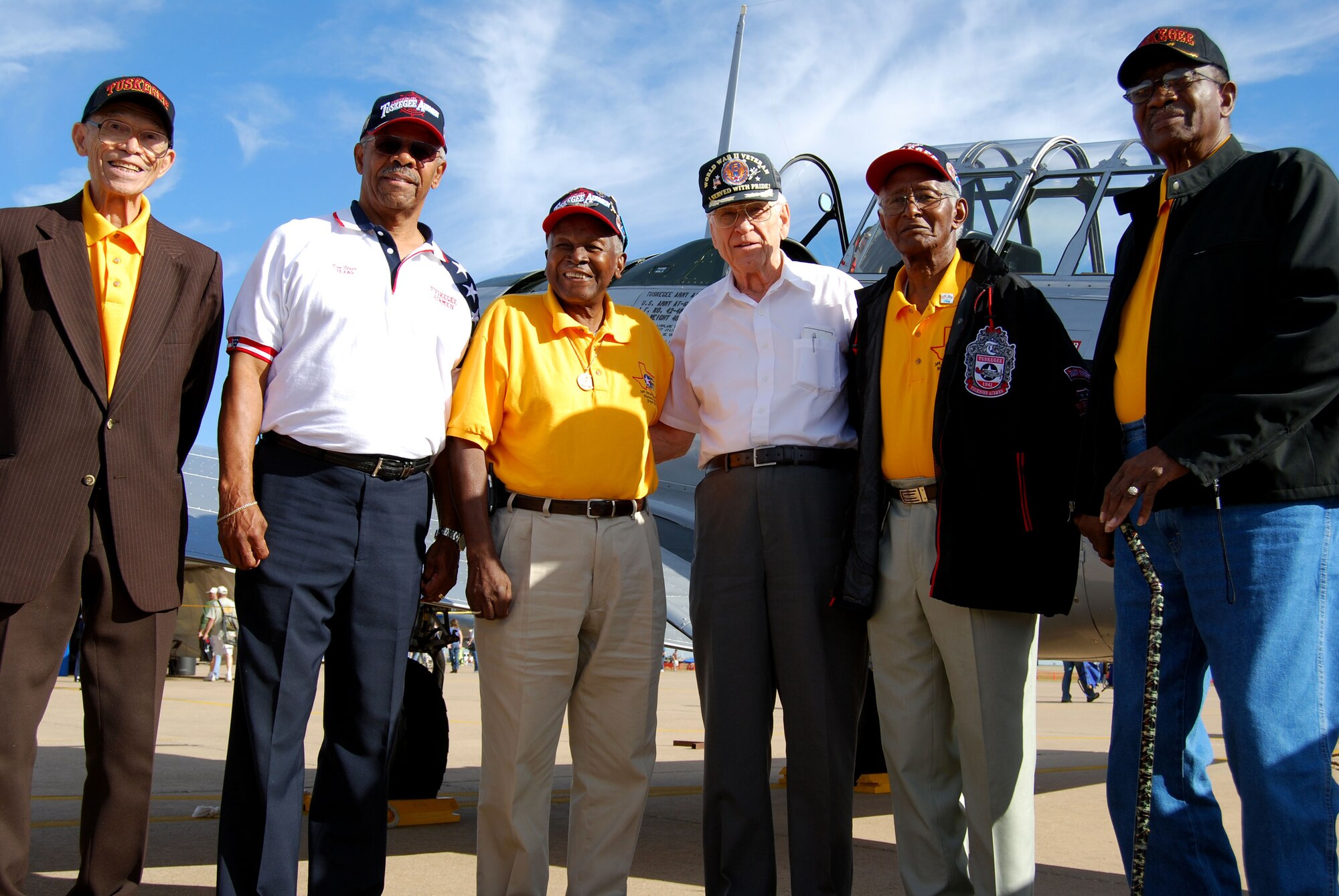 Airmen Living History display was present to share their heritage. Pictured, from left to right, in front of a T-6 Texan flown at Tuskegee Army Air Field, Ala., include Leroy Cleaver, ainstrucotr and pilot during World War II; Don Elder, a crew chief with the 99th Fighter Squadron; Calvin Spann, a fighter pilot with the 100th Fighter Squadron; retired Maj. John Ferris, a B-24 pilot escorted on 17 combat missions by the Tuskegee Airmen; John Flannagan, a communications technician; and Joseph Montgomery, a civil engineer. (U.S. Air Force photo/John Ingle)