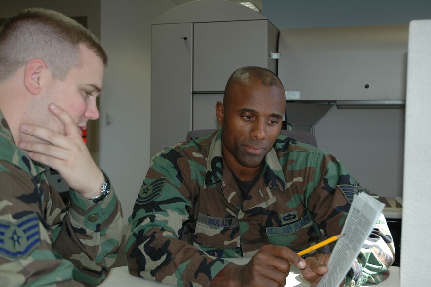YOUNGSTOWN AIR RESERVE STATION, Ohio — Tech Sgt. Khalid Mulazim points out a finance issue to Staff Sgt. Michael Hollows during the October UTA here. Both sergeants are military pay technicians in the 910th AW Finance office. This summer, Sergeant Mulazim became the national champion in the men?s 400-meter dash at the USA National Masters Championship meet in Maine. U.S. Air Force photo/Senior Airman Ann Wilkins Jefferson