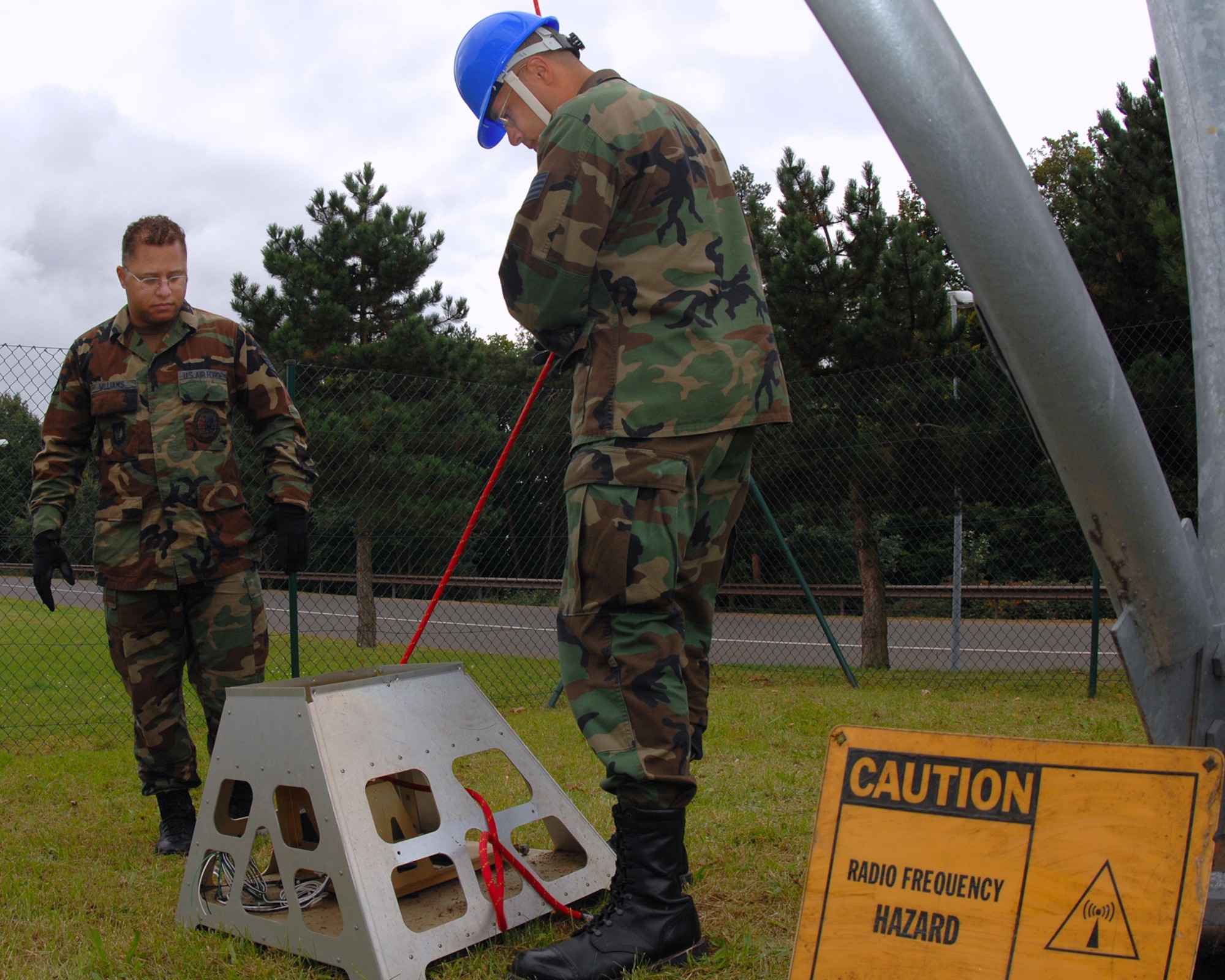 Staff Sgt. Jamie Williams, left, and Staff Sgt. Matthew Nell, 1st Communications Maintenance Squadron, retrieve a weather radar pedestal after it was removed from a radar tower on Sembach.