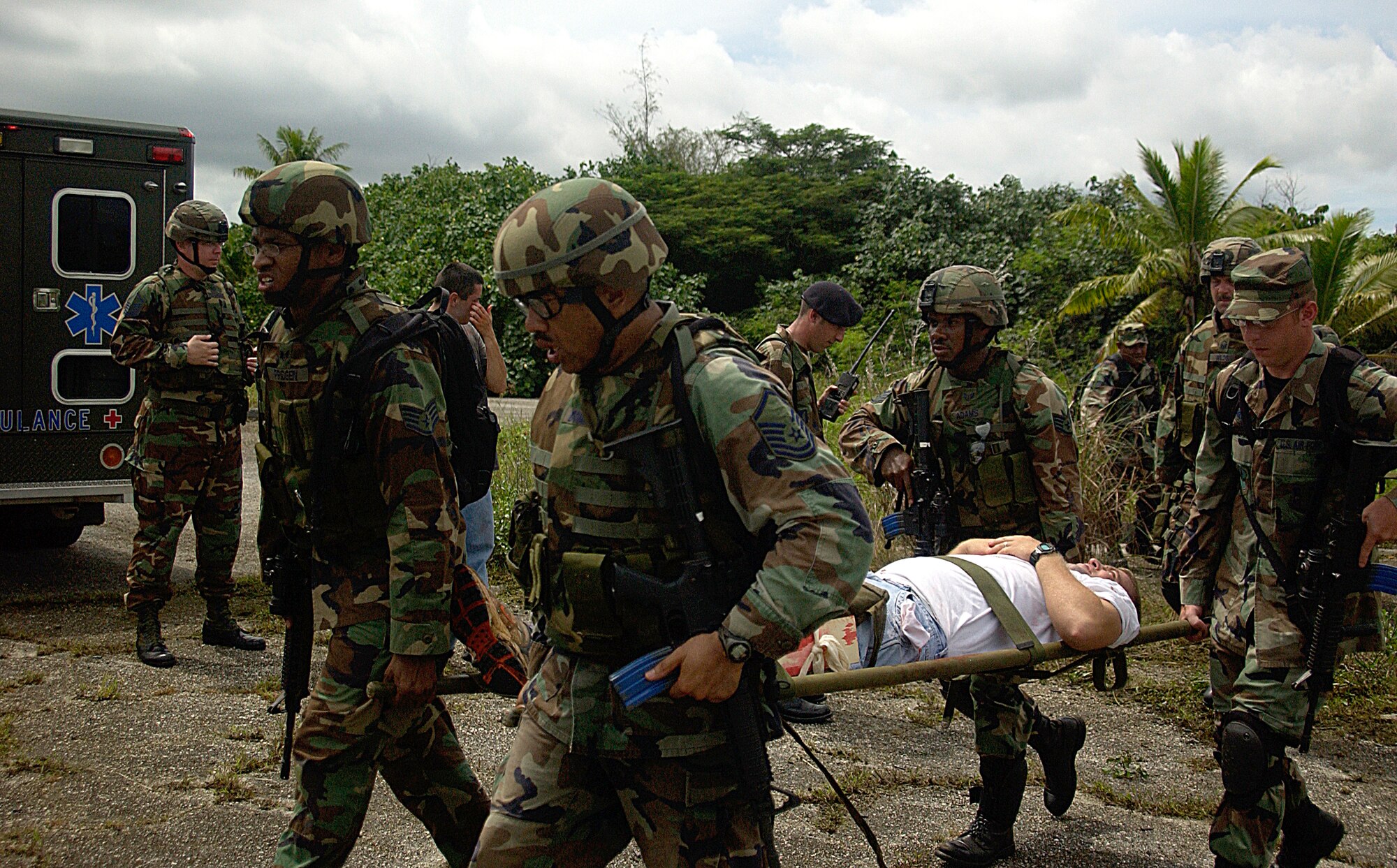 Staff Sgt. Juan Pridgen and Master Sgt. David Domingo, both from the 36th Contingency Response Group, lead in the transportation of a simulated casualty during a field traing exercise Oct. 18.  (U.S. Air Force Photo/Airman 1st Class Carissa Morgan)