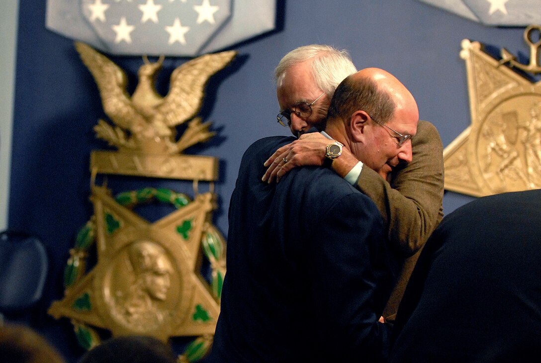Navy Secretary Donald Winter, left, embraces Daniel Murphy after speaking to the audience during a ceremony in which Murphy's son, Navy Lt. Michael P. Murphy, a SEAL killed in combat in Afghansitan, was inducted into the Hall of Heroes at the Pentagon, Oct. 23, 2007.