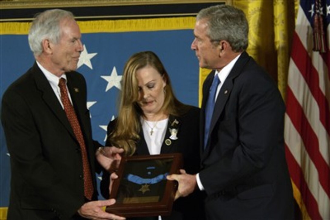 President George W. Bush (right) presents the Medal of Honor to Daniel and Maureen Murphy, the parents of U.S. Navy Lt. Michael Murphy, a Navy SEAL killed during a reconnaissance mission near Asadabad, Afghanistan, on June 28, 2005, during a ceremony at the White House on Oct. 22, 2007.  Murphy is the first service member to receive the medal for actions during Operation Enduring Freedom and the first Navy recipient of the medal since Vietnam. Daniel and Maureen Murphy accepted the posthumous award on behalf of their son. 