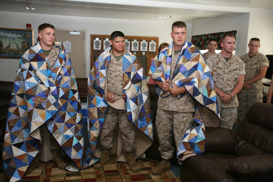 Lance Corporals John Banta, T.J. Cothran, Matthew Reno received quilts from the Quilters of Eastern Washington State. These Marines were chosen due to injuries sustained in combat operations in Iraq.