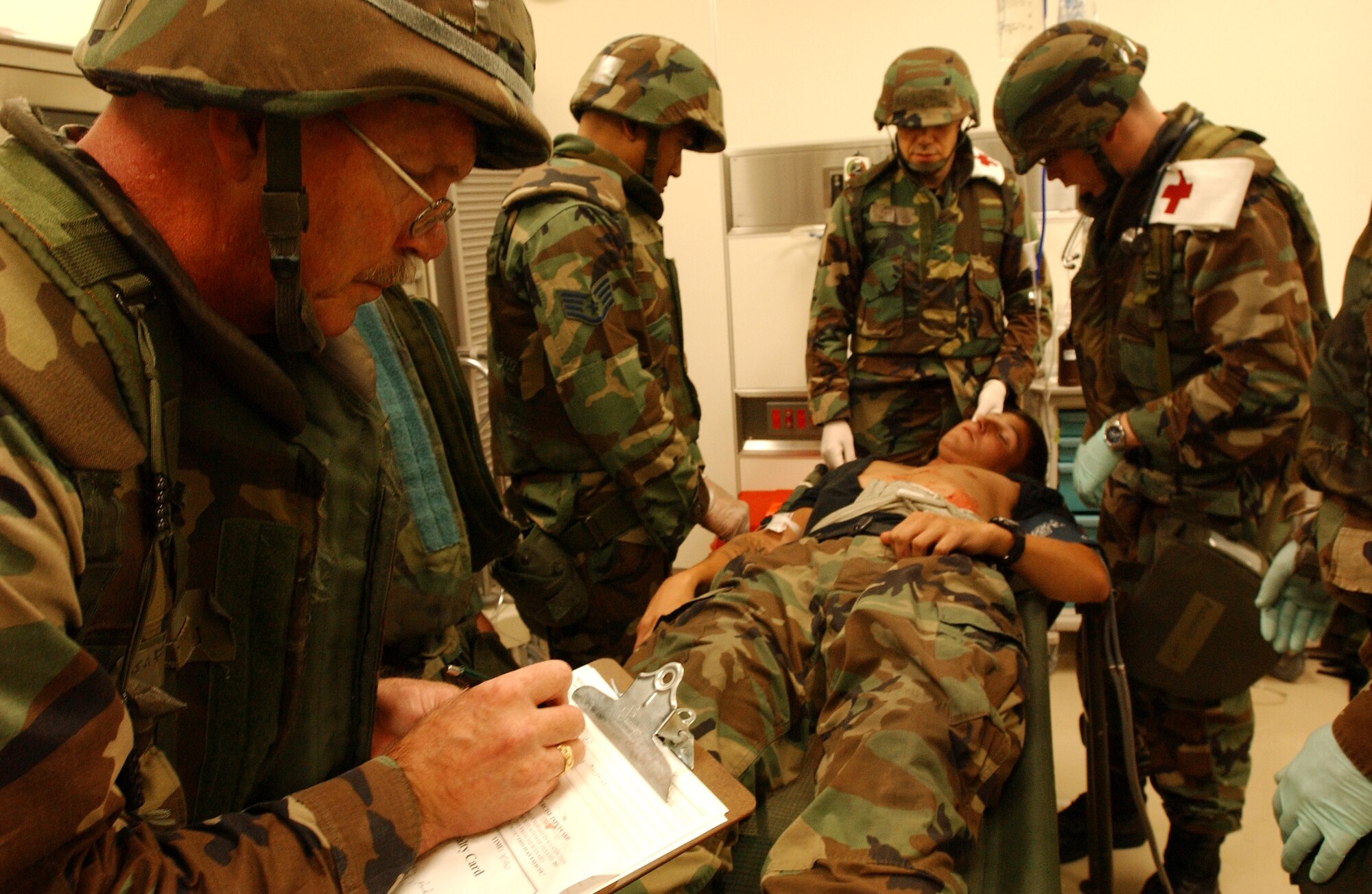 Lt. Col. Pete Sorenson, 18th Medical Group, writes down the conditions of a patient before transporting them to Lester Hospital Oct. 24, 2007, at Kadena Air Base, Japan. The mass casualty scenario helped Airmen train on treating wounds and applying basic life-saving steps during the Local Operational Readiness Exercise Beverly High 08-1. (U.S. Air Force photo/Tech. Sgt. Rey Ramon) 

