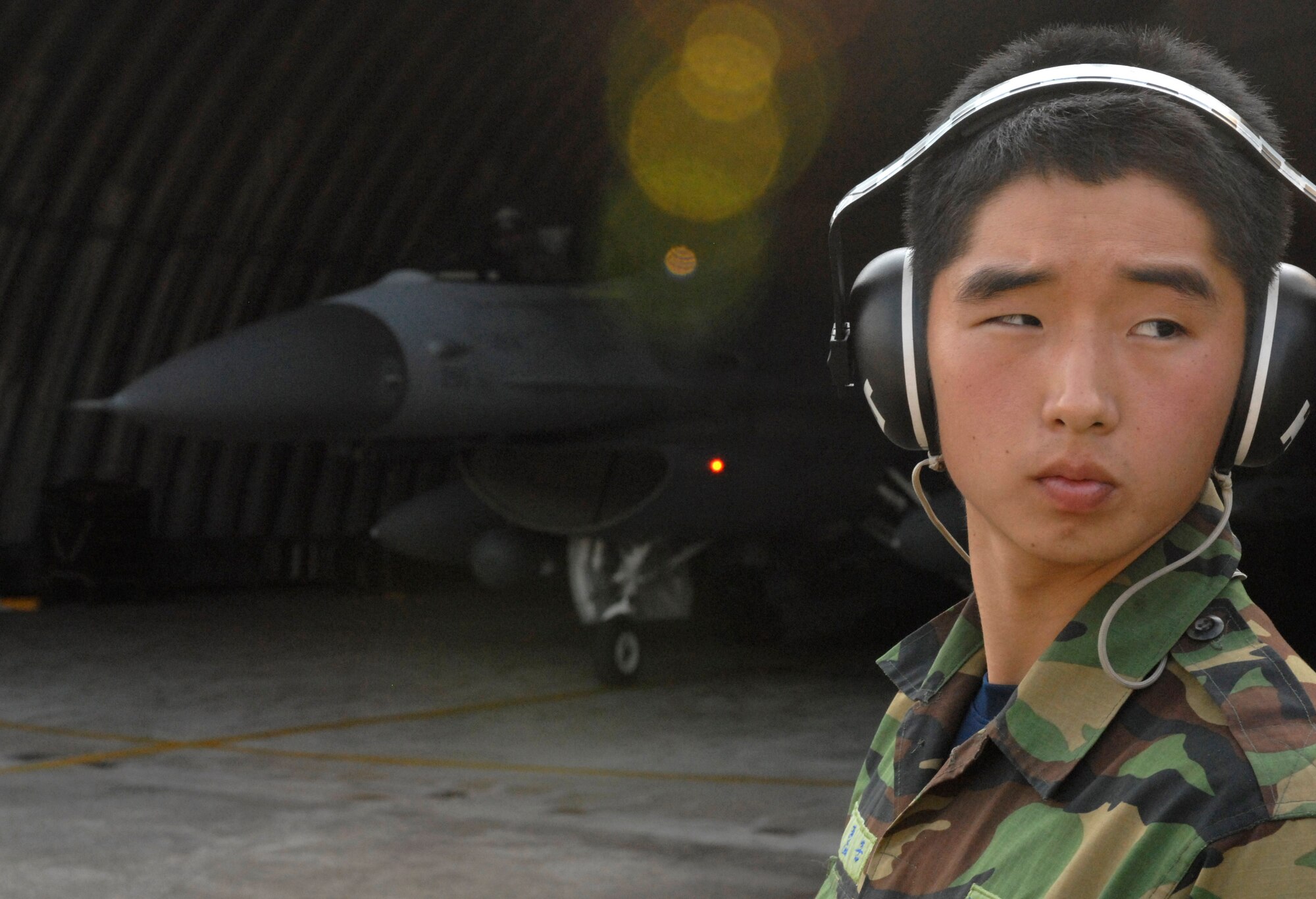 JUNGWON AIR BASE, South Korea -- Republic of Korea Air Force Staff Sgt. Hyunjun Choi, a maintainer from the 161st Maintenance Squadron, takes a moment to look around as he waits to assist with the launch of an F-16 Fighting Falcon from the 8th Fighter Wing, Kunsan Air Base, South Korea during a Buddy Wing program exercise here Oct. 24. The Buddy Wing program is a way for U.S. Air Force and Republic of Korea Air Force Airmen to develop teamwork, exchange ideas and improve war time tactics.  (U.S. Air Force photo/Senior Airman Steven R. Doty)