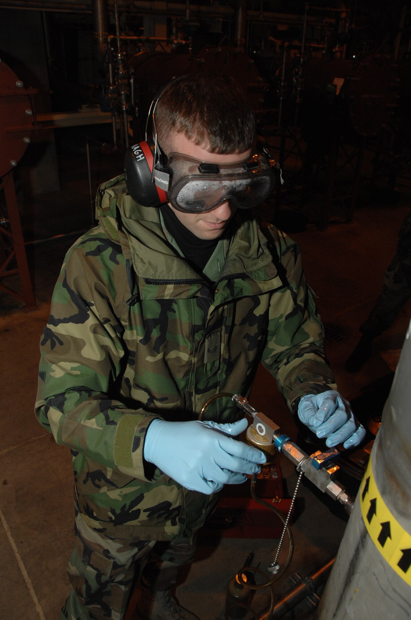 EIELSON AIR FORCE BASE, Alaska --  Airman 1st Class Sean McDonagh, 354th Logistic Readiness Squadron fuels laboratory technician, connects a Gammon Inline Sampler to a fuel pump Oct. 24, 2007, at the Oscar Pump House located near the flight line. Making sure the fuel used by the aircraft here at Eielson is always good to go, Airman McDonagh helps assure the process by constantly sampling the fuel lines and also the trucks that distribute it to the aircraft.   (U.S. Air Force photo by Airman 1st Class Christopher Griffin)