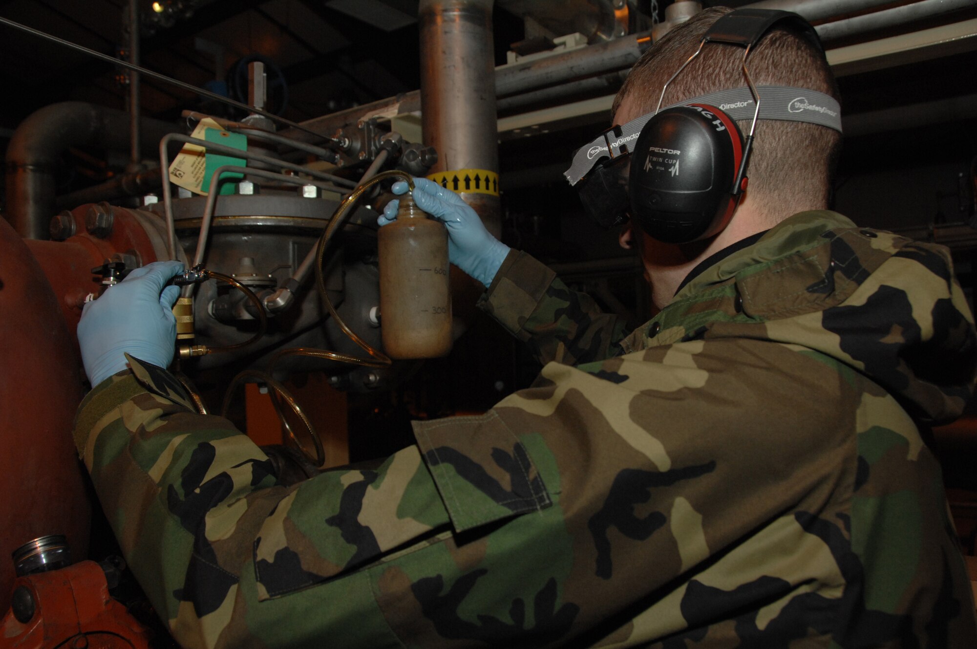 EIELSON AIR FORCE BASE, Alaska --  Airman 1st Class Sean McDonagh, 354th Logistic Readiness Squadron fuels laboratory technician, connects a Gammon Inline Sampler which is used to detect free water in fuel Oct. 24, 2007, at the Oscar Pump House. Making sure the fuel used by the aircraft here at Eielson is always good to go, Airman McDonagh helps assure the process by constantly sampling the fuel lines and also the trucks that distribute it to the aircraft. (U.S. Air Force photo by Airman 1st Class Christopher Griffin)