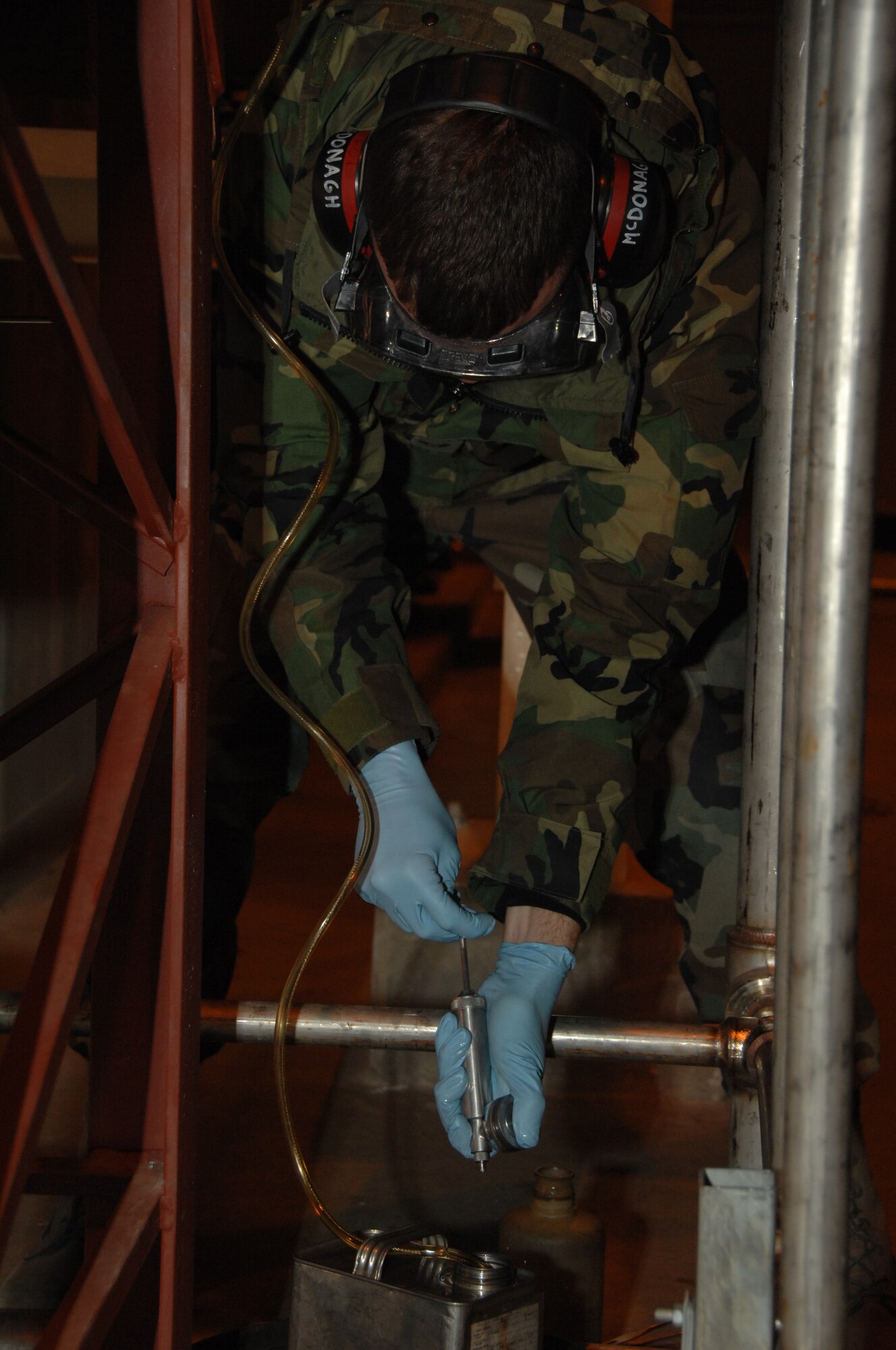 EIELSON AIR FORCE BASE, Alaska --  Airman 1st Class Sean McDonagh, 354th Logistic Readiness Squadron fuels laboratory technician, uses a syringe to separate fuel into containers Oct. 24, 2007, at the Oscar Pump House located near flight line. Making sure the fuel used by the aircraft here at Eielson is always good to go, Airman McDonagh helps assure the process by constantly sampling the fuel lines and also the trucks that distribute it to the aircraft. (U.S. Air Force photo by Airman 1st Class Christopher Griffin)