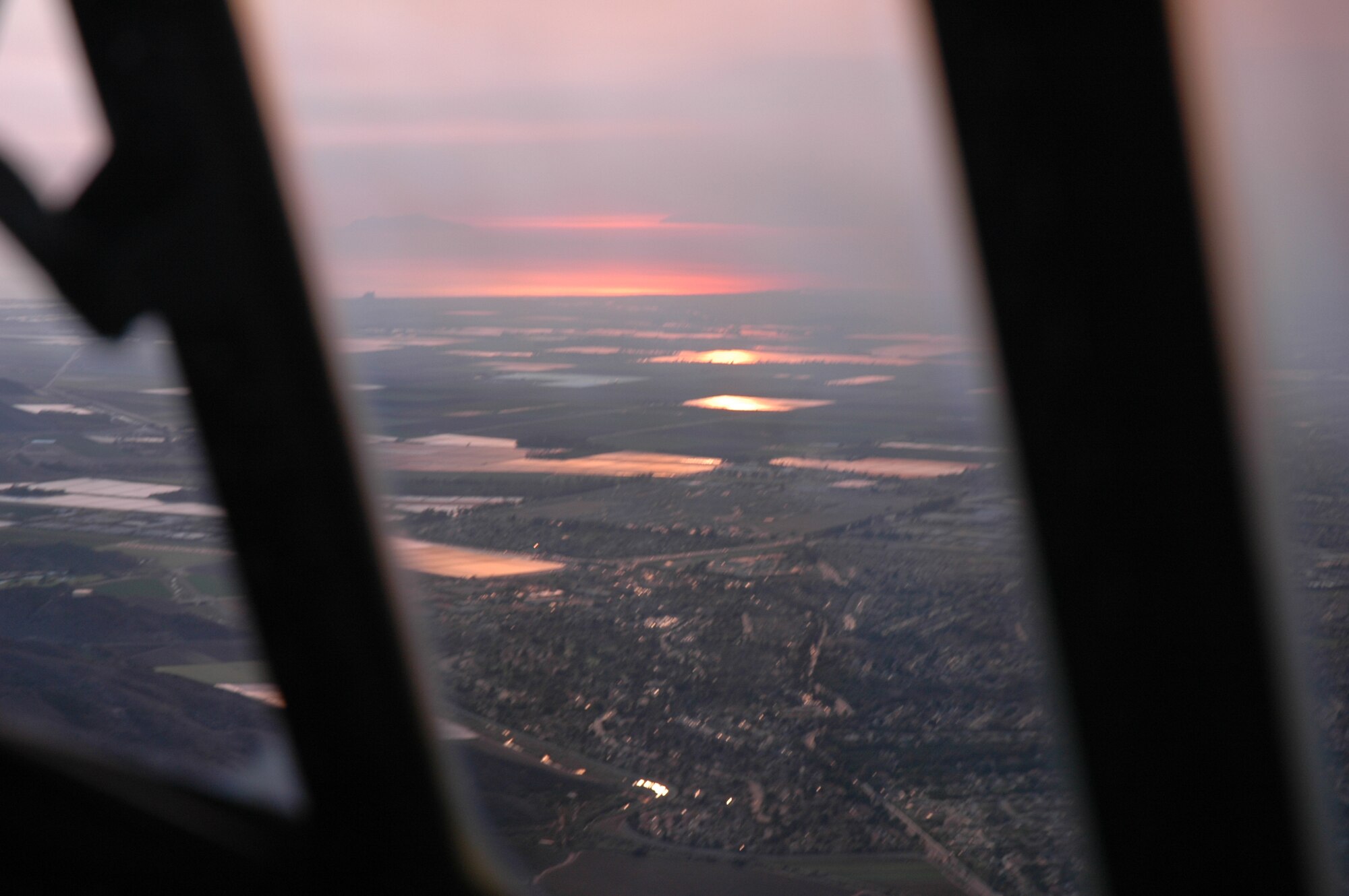 The glow of massive fires in the distance creates the illusion of a sunset, even in the middle of the day. (U.S. Air Force photo by 2nd Lt. Jonathan Simmons)