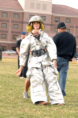 Airman Ashley Cooke, a member of the 57th Aircraft Maintenance Squadron, transports a “dummy” as part of the 2007 Fire Prevention Muster held here, Oct. 12. (U.S. Air Force photo by Airman 1st Class Brian Ybarbo) 