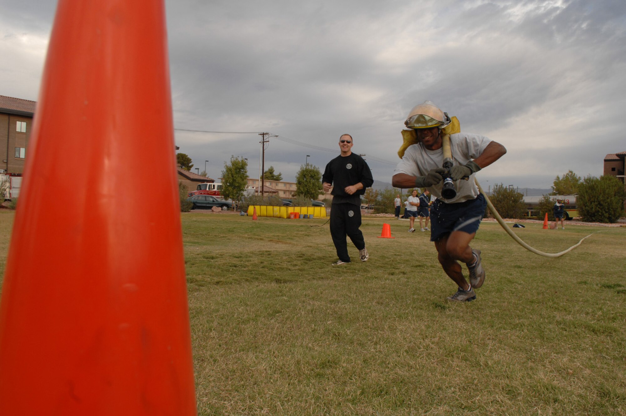 Senior Airman Derrick Mydell, a protocol specialist assigned to the U.S. Air Force Warfare Center, competes in a hose relay as a member of Legal Team II as part of the 2007 Fire Prevention Muster held here, Oct. 12. (U.S. Air Force photo by Airman 1st Class Brian Ybarbo)