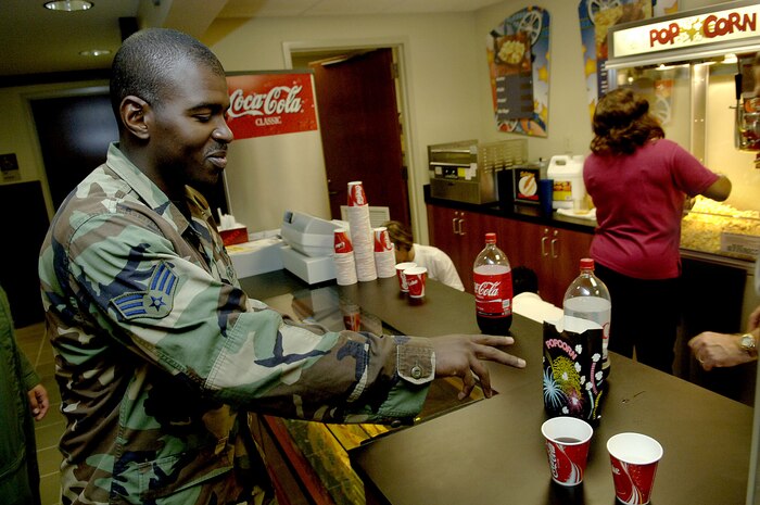 Senior Airman Willy Thomas from the 1st Combat Camera Squadron, gets a free soda and popcorn after the ribbon-cutting ceremony of the newly rennovated base theater Thursday on Charleston AFB. (U.S. Air Force photo/Airman 1st Class Nicholas Pilch)