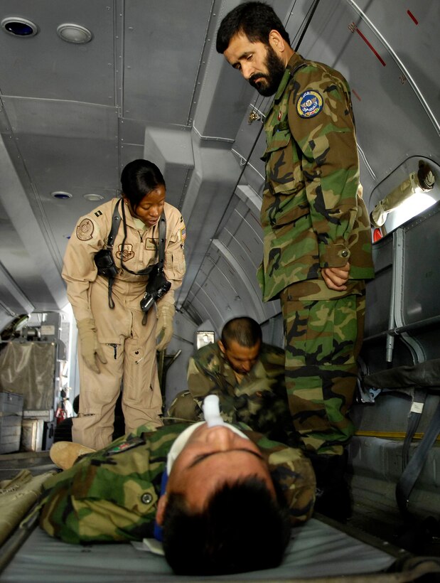 Capt. Marilyn Thomas observes a medical evacuation team as they floor load a patient onto an AN-32 cargo plane during an Oct. 20 training exercise held at Kabul International Airport, Afghanistan. Captain Thomas is a flight nurse and an Afghan national army air corps medical mentor with the air corps advisers group. She is deployed from Scott Air Force Base, Ill. (U.S. Air Force photo/Staff Sgt. Brian Ferguson)