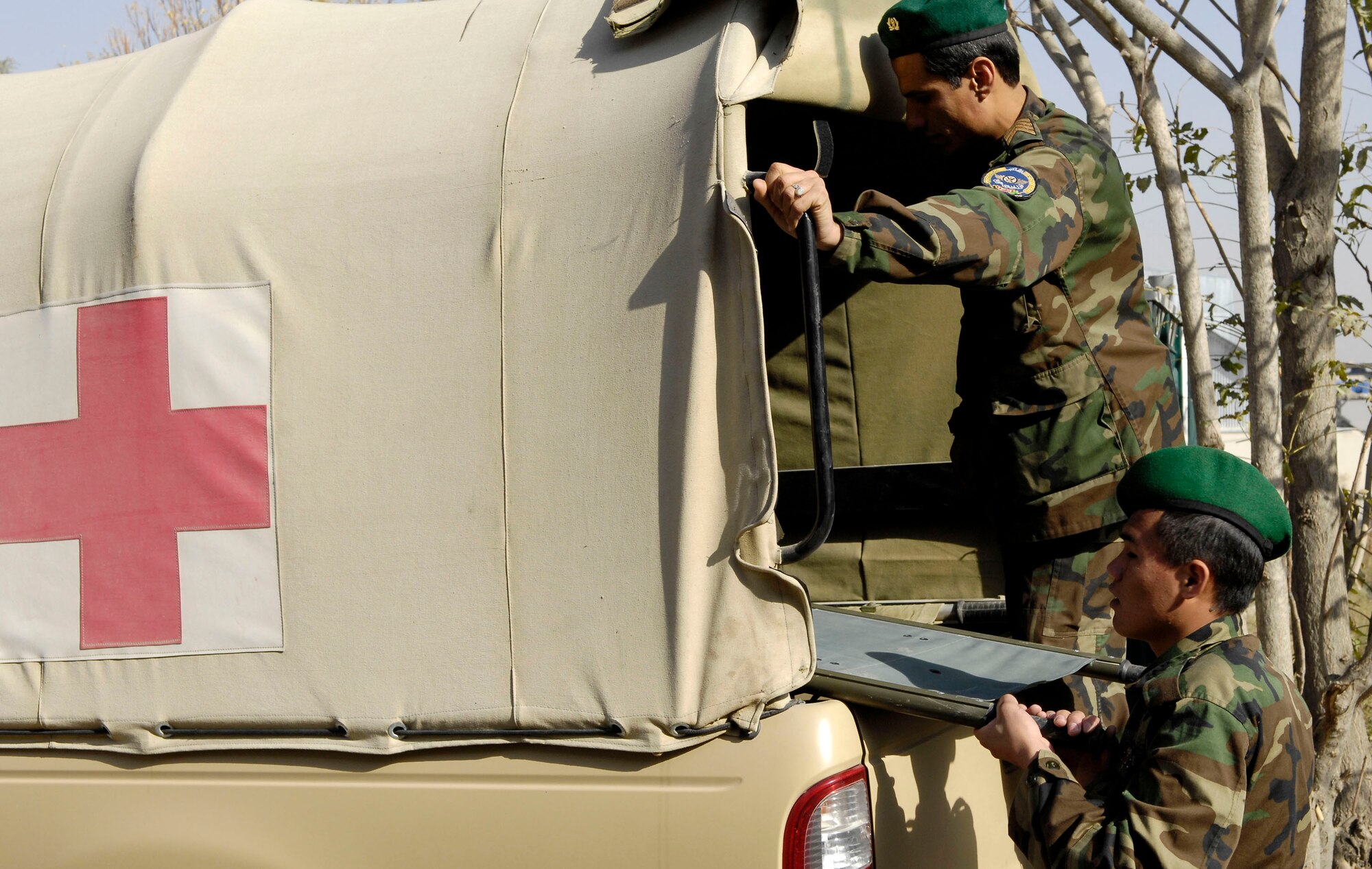 Two Afghan national army air corps medical technicians load a litter into the back of a medical vehicle Oct. 20 at Kabul International Airport, Afghanistan. The litter was used during a training exercise in which a patient was floor loaded onto an AN-32 cargo plane. The training keeps the medical staff here proficient in the skills needed to do their jobs. (U.S. Air Force photo/Staff Sgt. Brian Ferguson)
