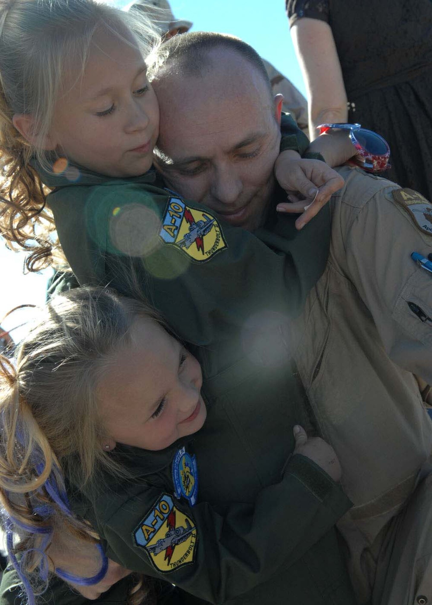 Captain Dennis Hargis, an A-10 Thunderbolt II pilot is greeted by his daughters, Paige, 7, and Summer, 4, after returning to home from a deployment to Afghanistan Oct. 23. Captain Hargis is assigned to the 354th Fighter Squadron. (U.S. Air Force photo/Senior Airman Christina D. Kinsey)