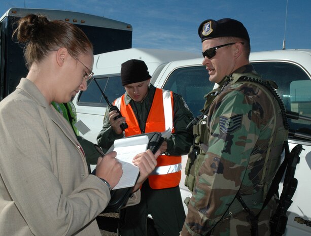 Special Agent Erin Delaney, Det. 806, Office of Special Investigations, asks Tech. Sgt. Shane Dynes, 341st Security Forces Group, about the details of a mock crime scene during an exercise at Malmstrom Oct. 23. During the three-day exercise, Malmstrom tested its initial implementation of the Air Force Incident Management Program. The program trains emergency response personnel and specialized teams from the base to speak a standardized language with their civilian counterparts when responding to any incident. (U.S. Air Force photo/Staff Sgt. Marcus McDonald)